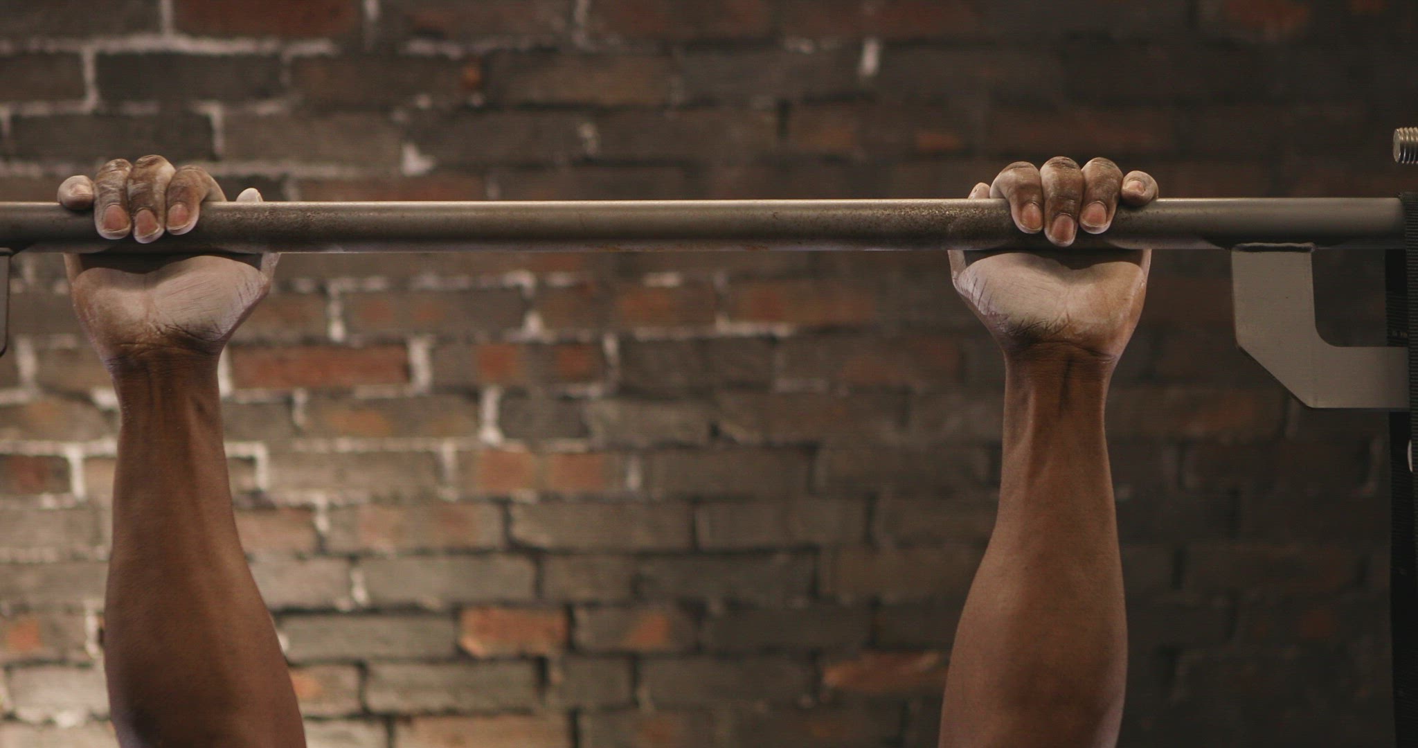 Man doing pull ups at gym