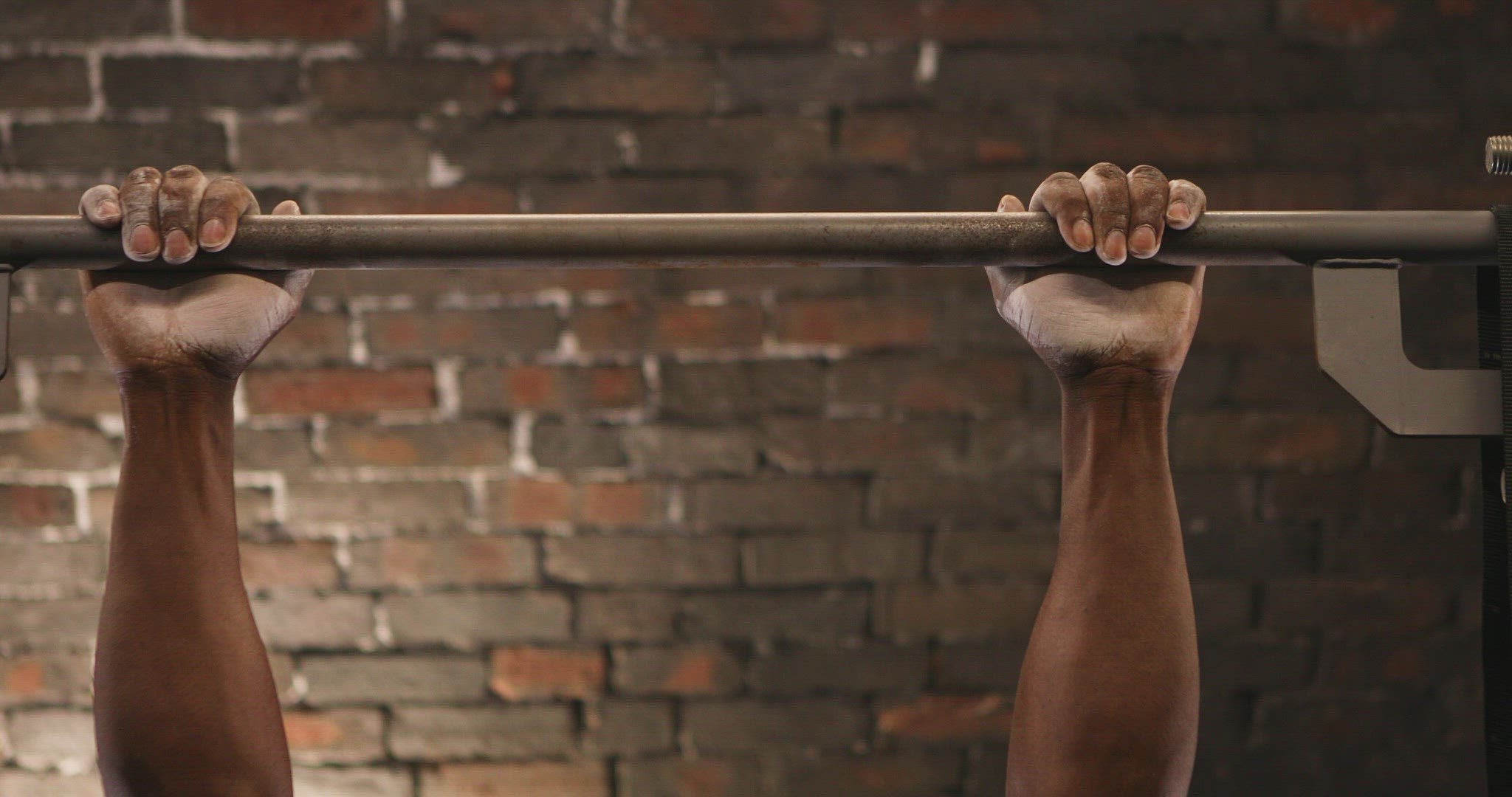 Man doing pull ups at gym