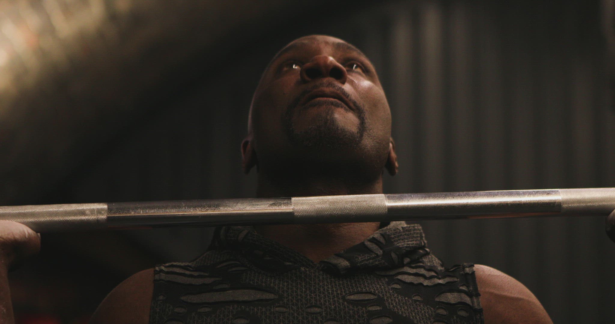 Man doing military press at gym