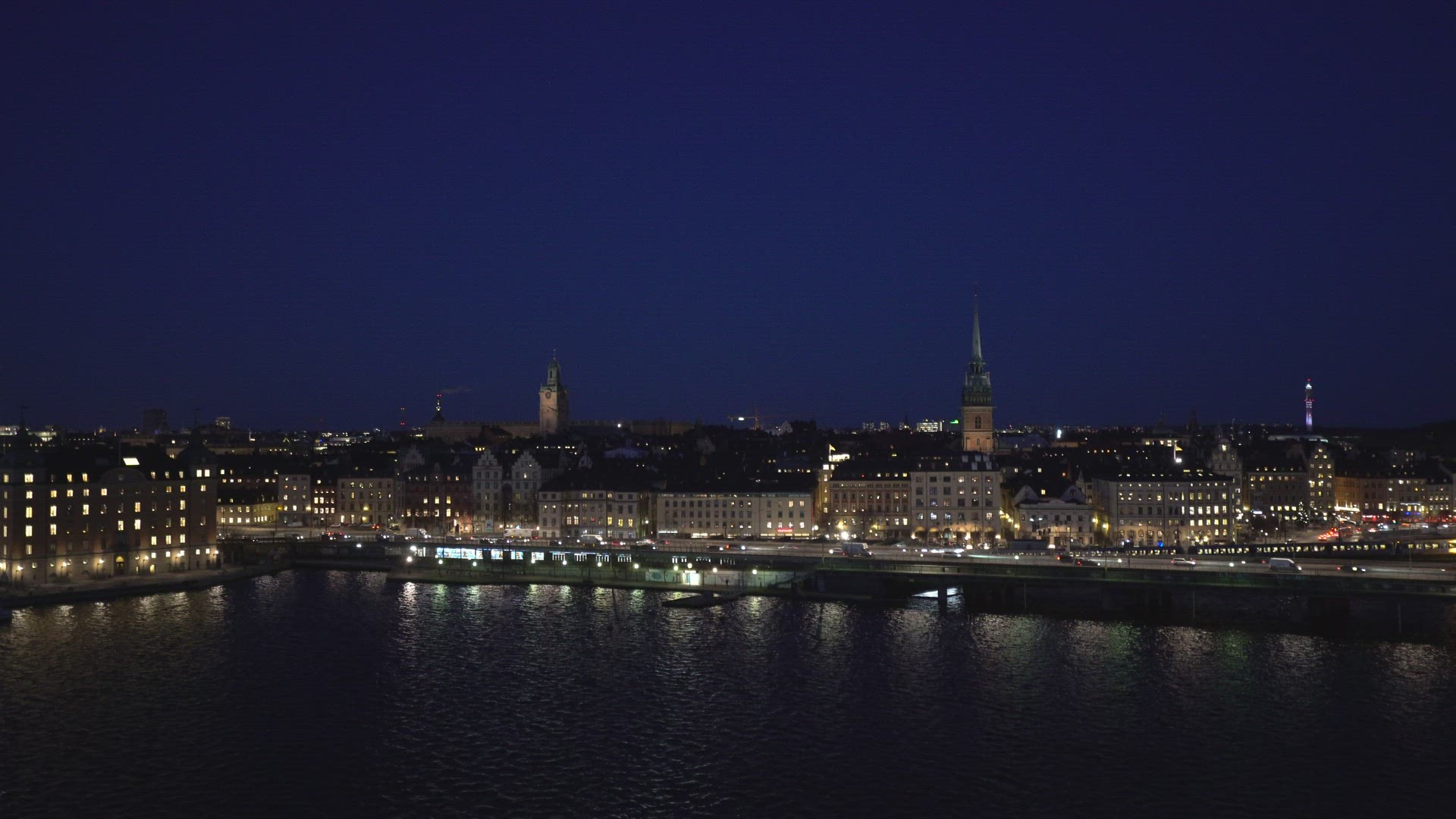 view over old town in stockholm - skyline - train arriving - evening night shot