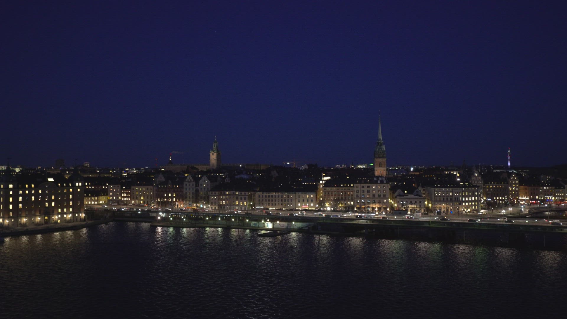 view over old town in stockholm - skyline - train leaving - evening night shot
