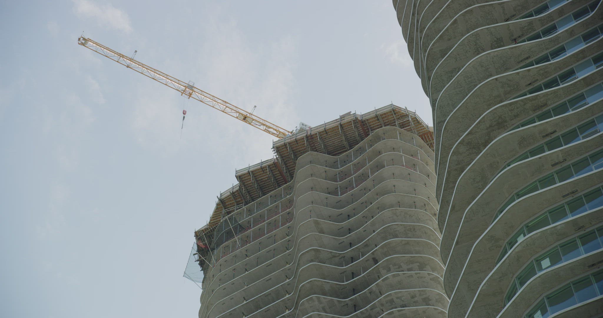 Crane over top of apartment building