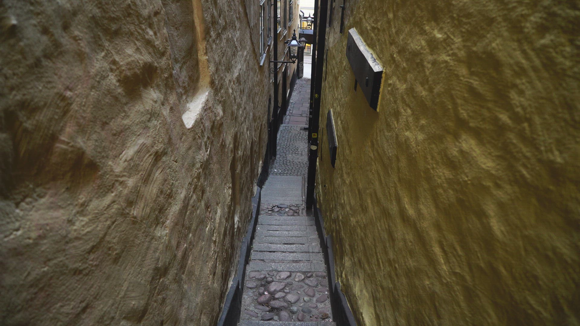 pov walking down stairs on steep narrow street in old town in Stockholm