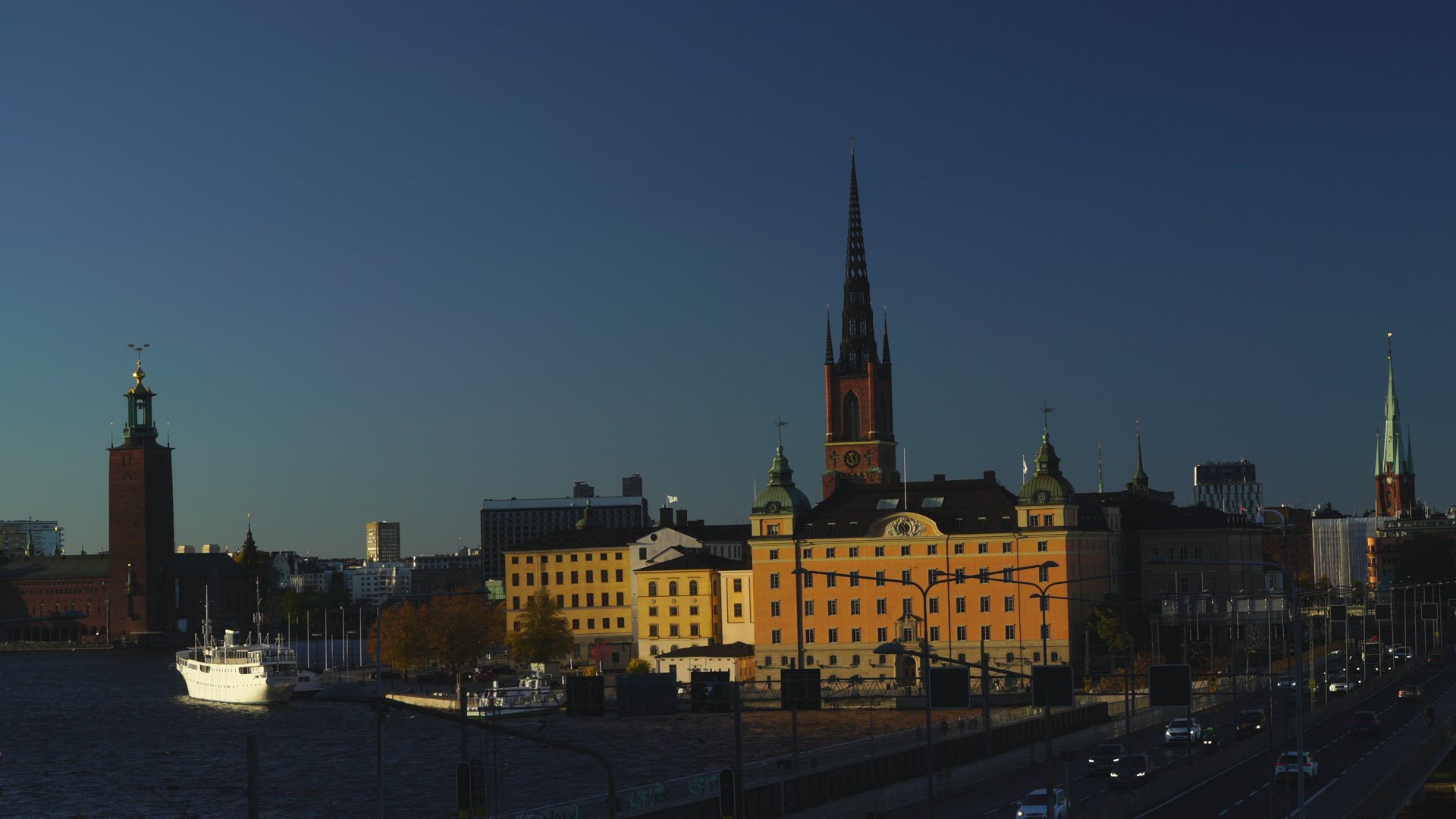 view Riddarholmen - golden hour - skyline - traffic cars and train passing