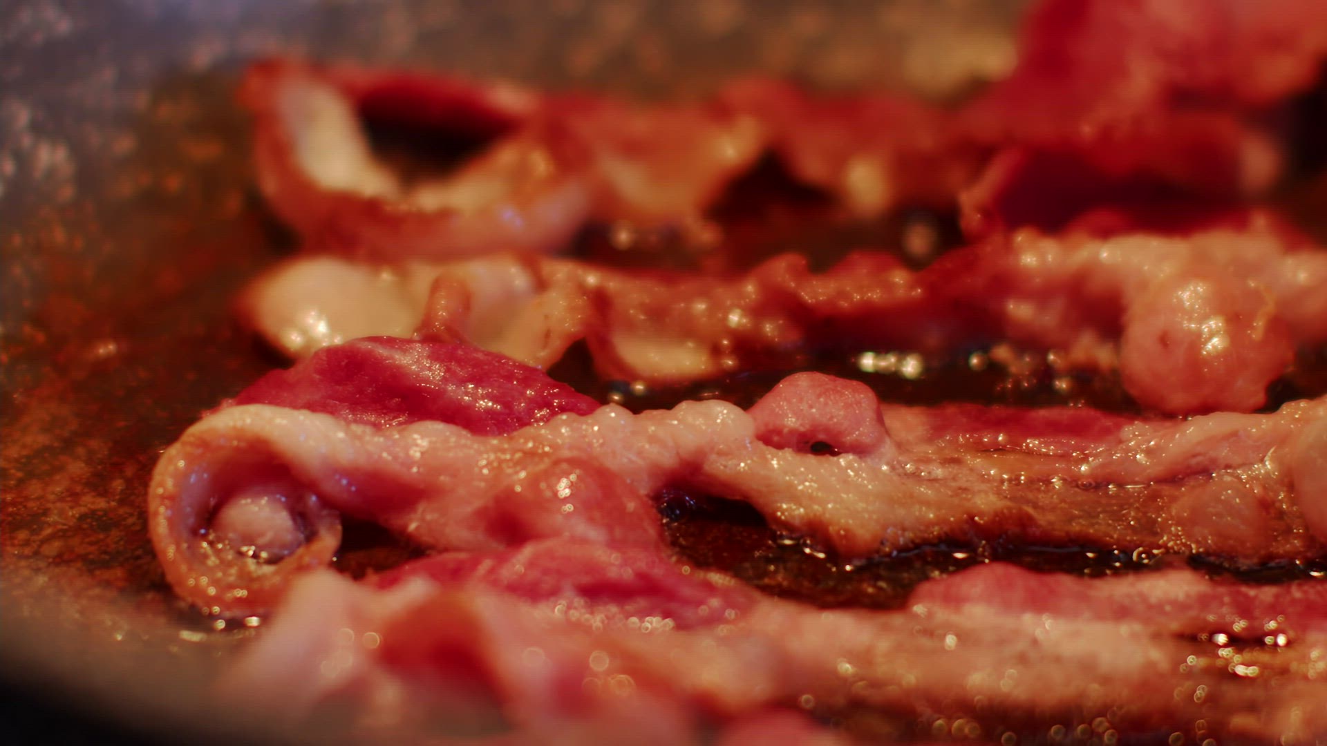 Pan fried bacon flip in slow motion.