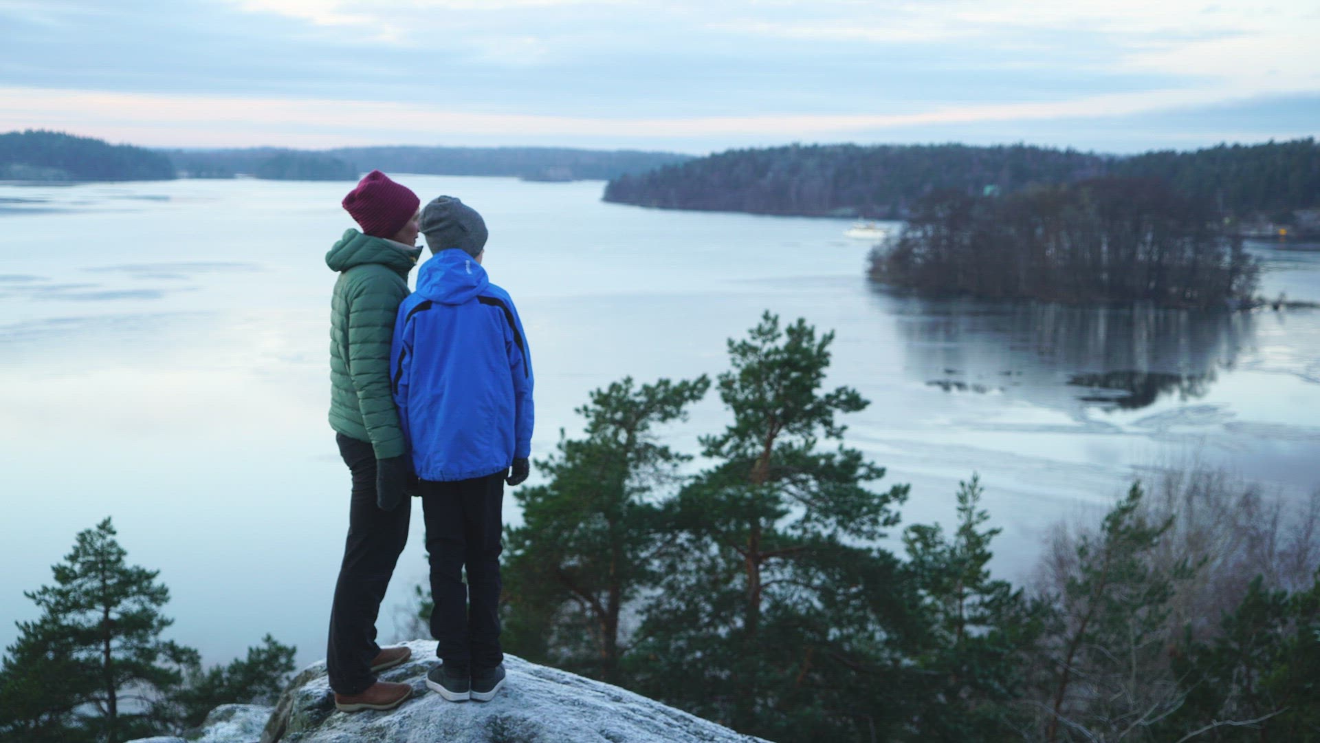 mother and child standing at viewpoint - looking out over wintry landscapes