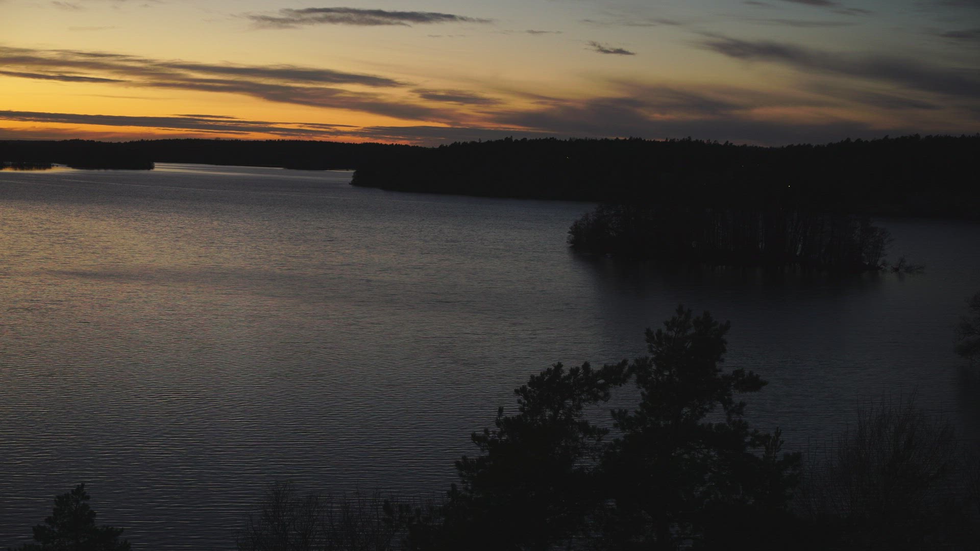 view over lake mälaren at sunset - coloured skies - evening - winter