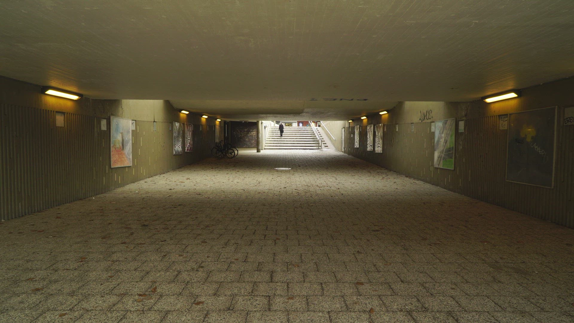 people walking through concrete underground tunnel in suburbian area  - Stockholm