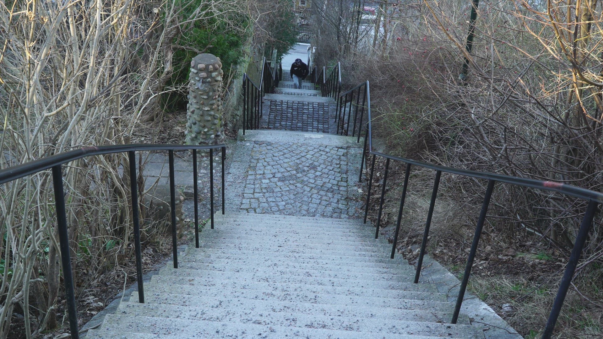 man ascending steep stairway - walking up many stairs