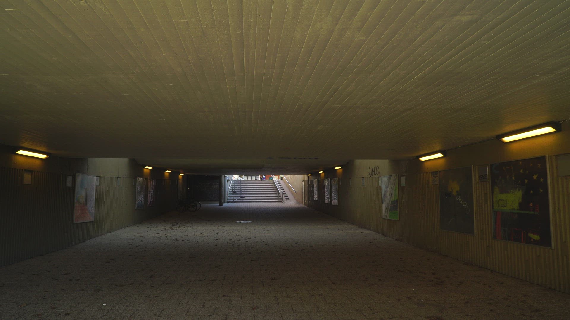 people walking through concrete underground tunnel in suburian area  - Stockholm