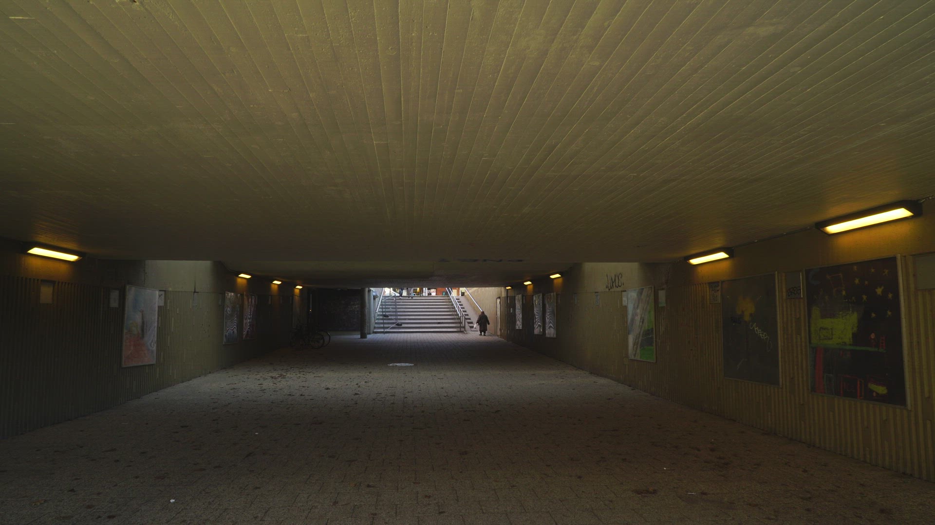 man walking through concrete underground tunnel in suburian area  - Stockholm