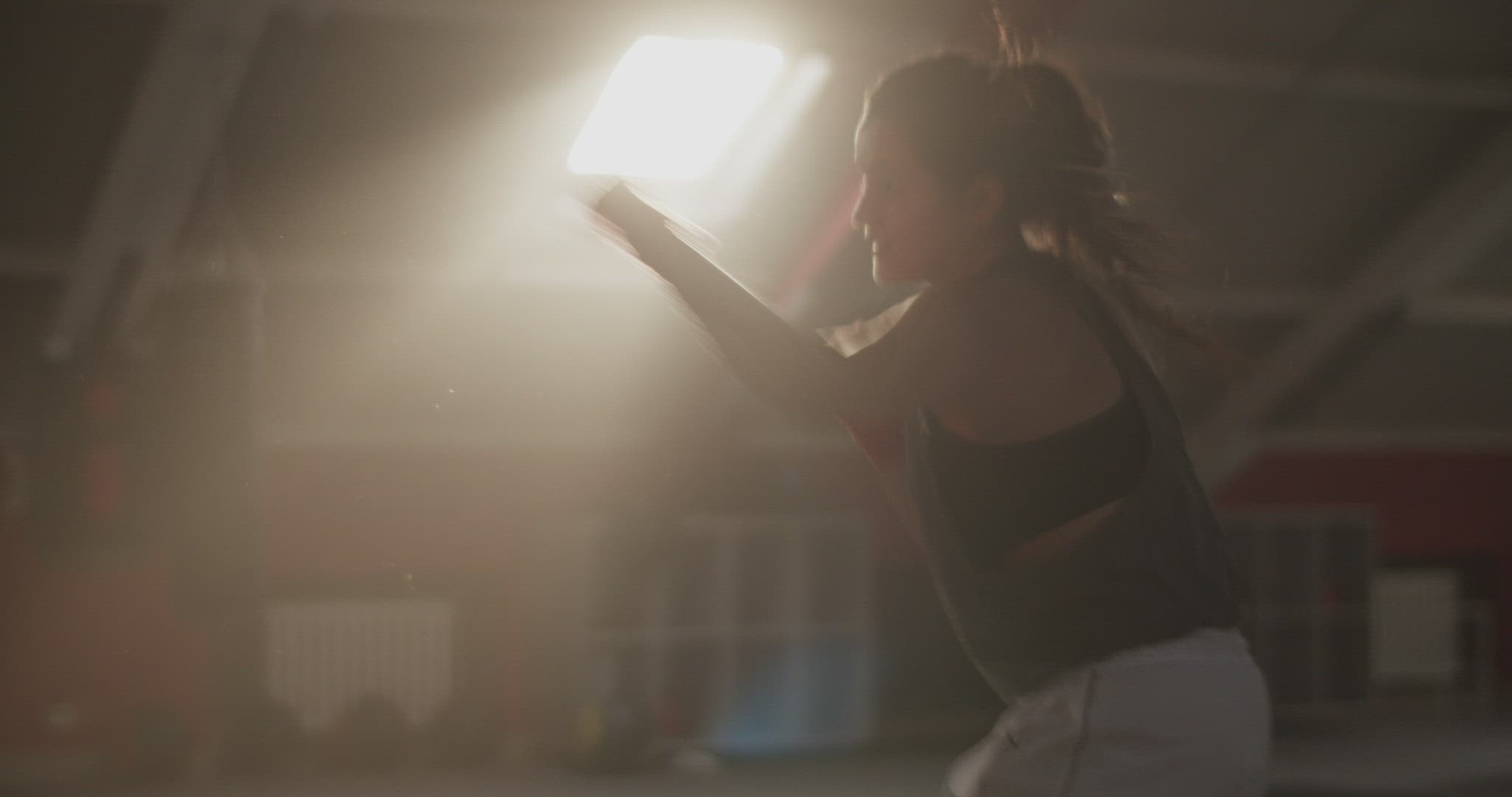 Sportswoman shadow boxing under sunlight
