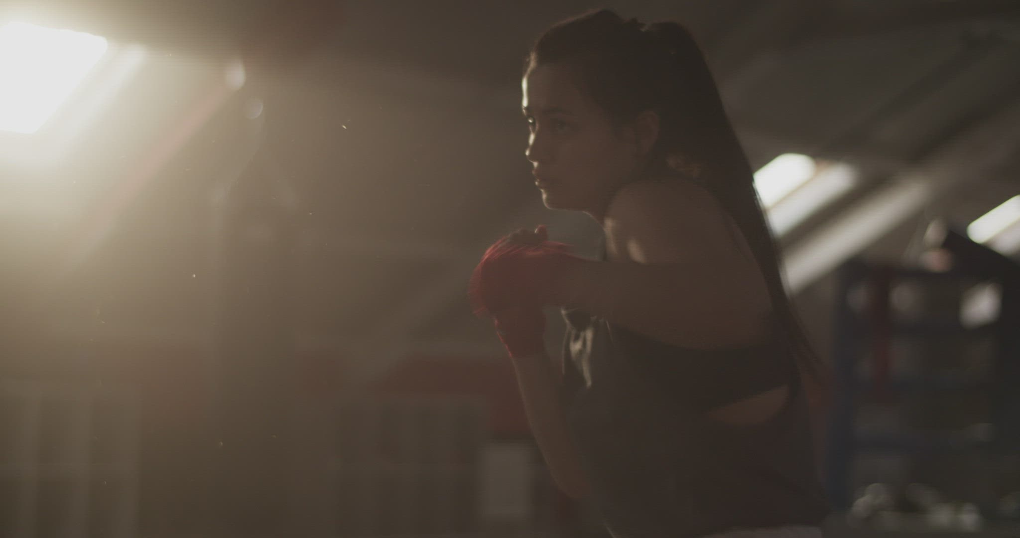 Sportswoman shadow boxing under sunlight