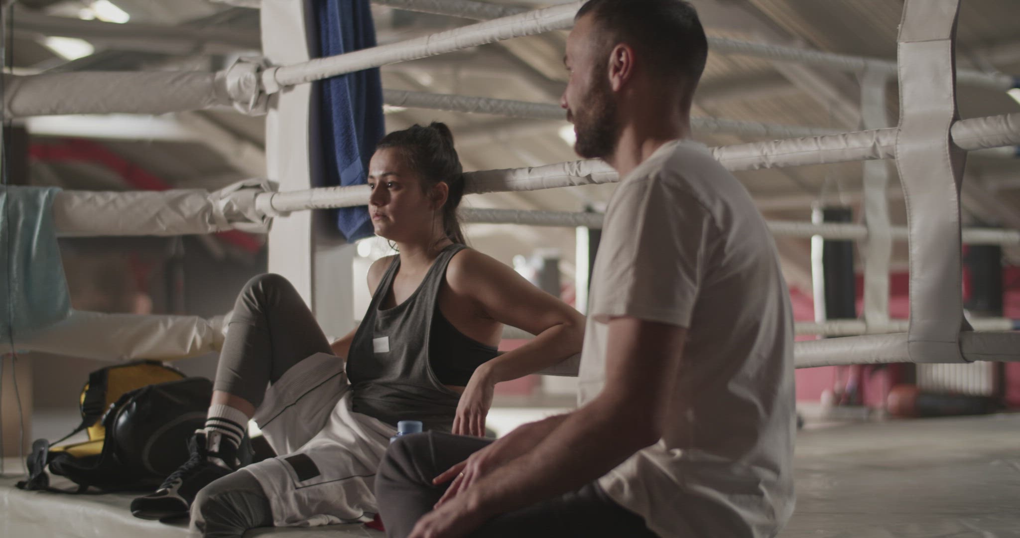 Boxing coach speaking to sportswoman
