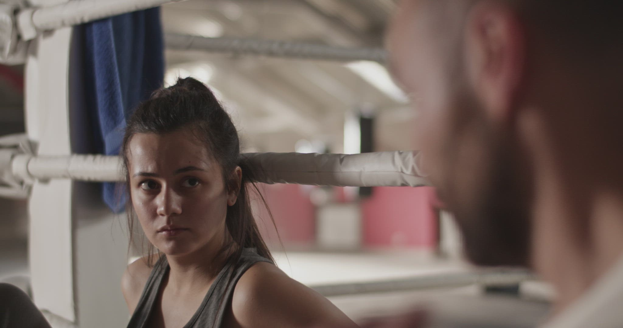 Female boxer listening to trainer