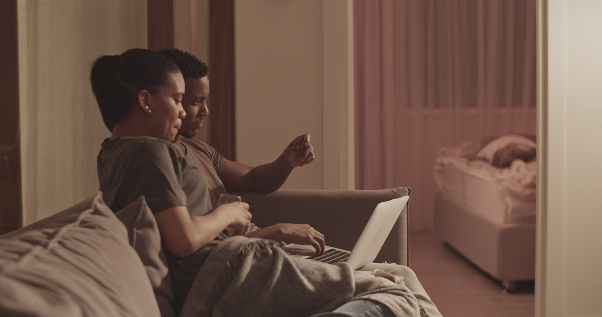 Man and woman shopping online on sofa