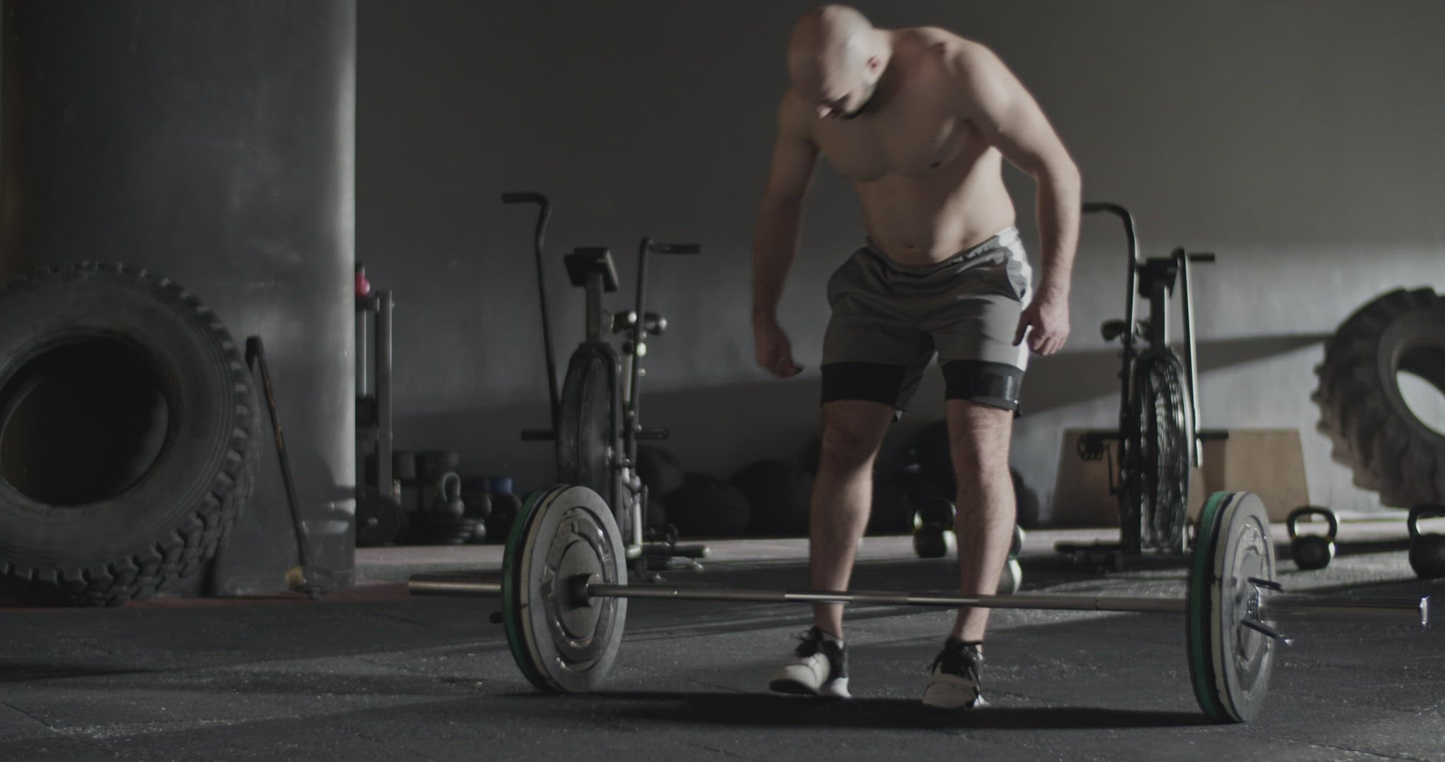 Strong sportsman in start position before snatch