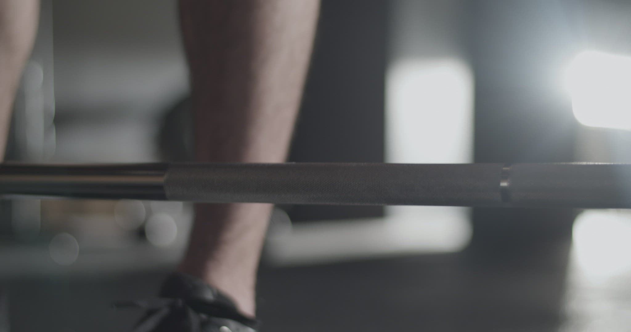 Cropped sportswoman preparing for deadlift exercise