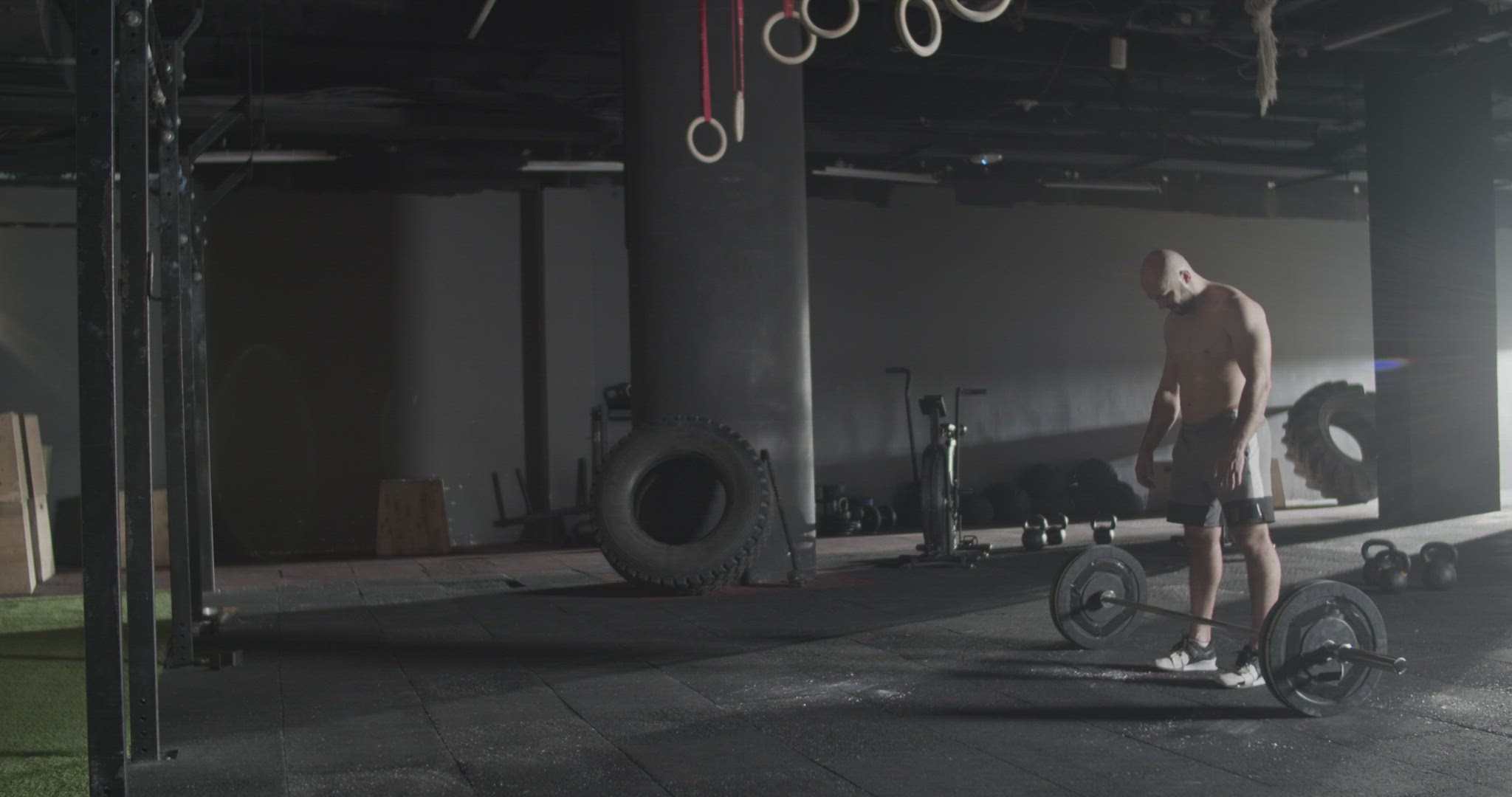 Athletic man doing clean and jerk exercise barbell in gym