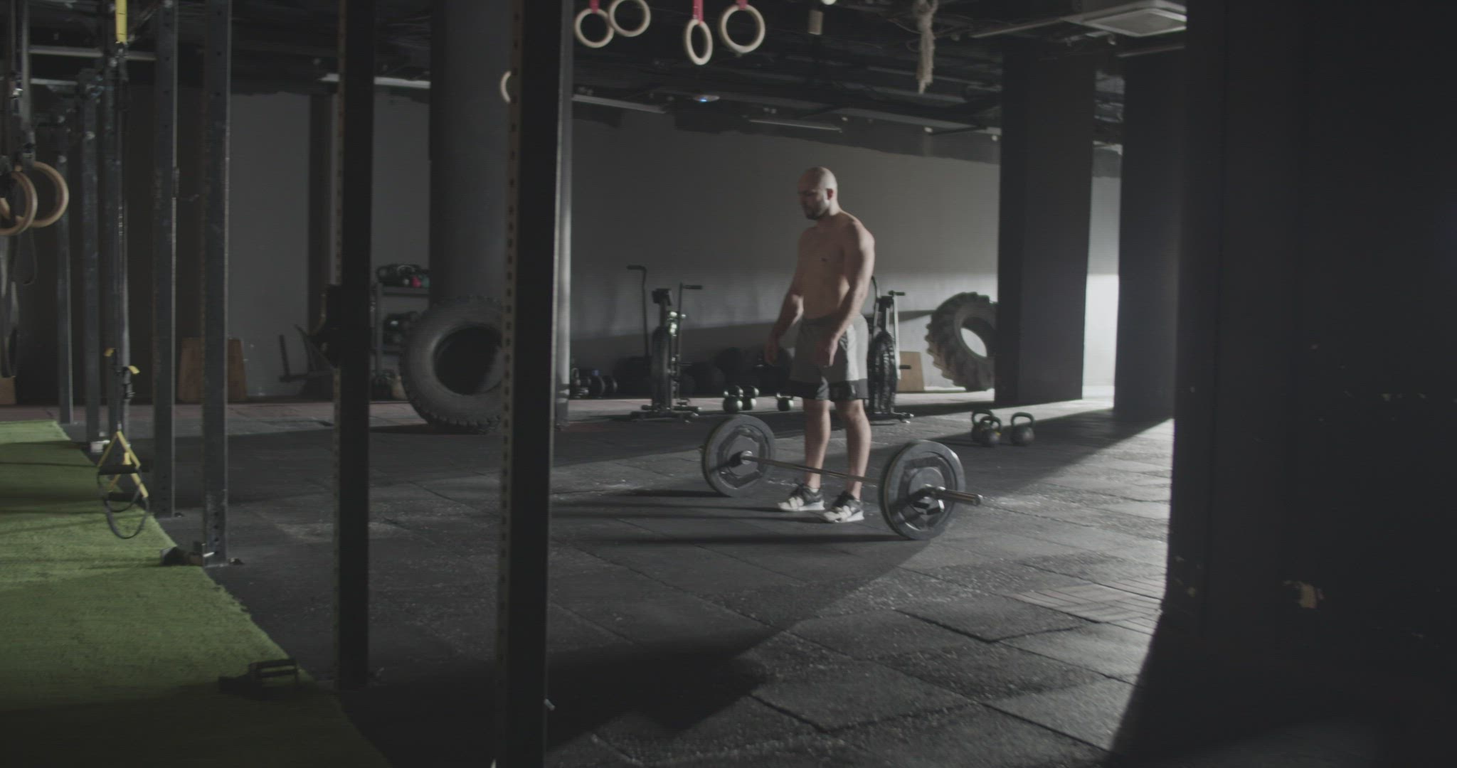 Athletic man doing clean and jerk exercise barbell in gym
