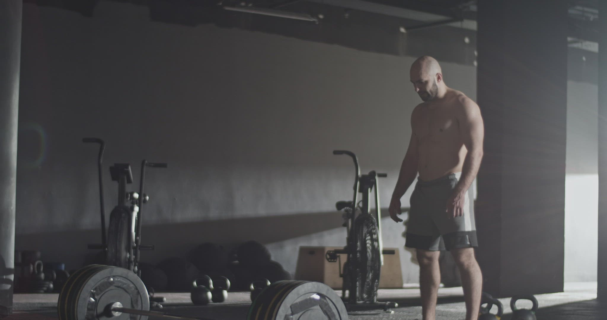 Furious sportsman doing deadlift attempt in gym