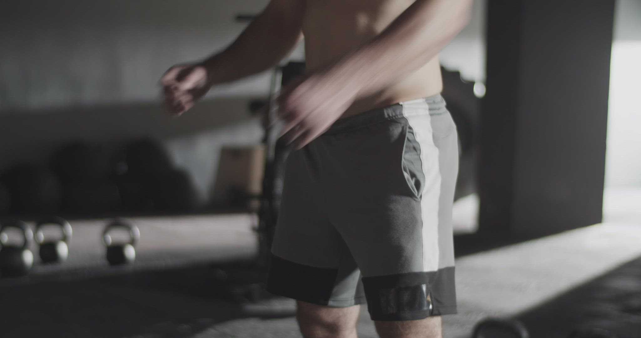 Determined sportsman warming up with barbell