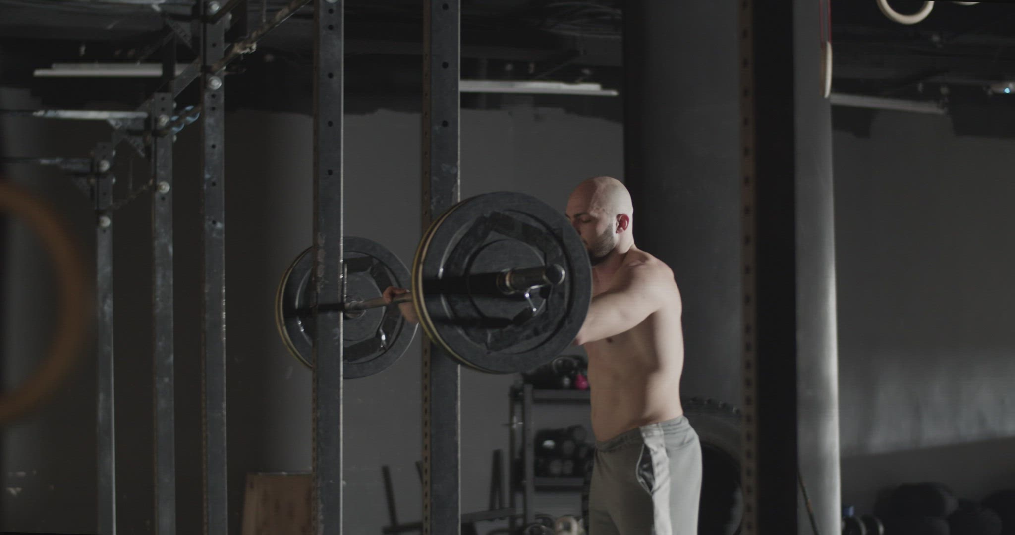 Athletic sportsman doing exercises and throwing barbell