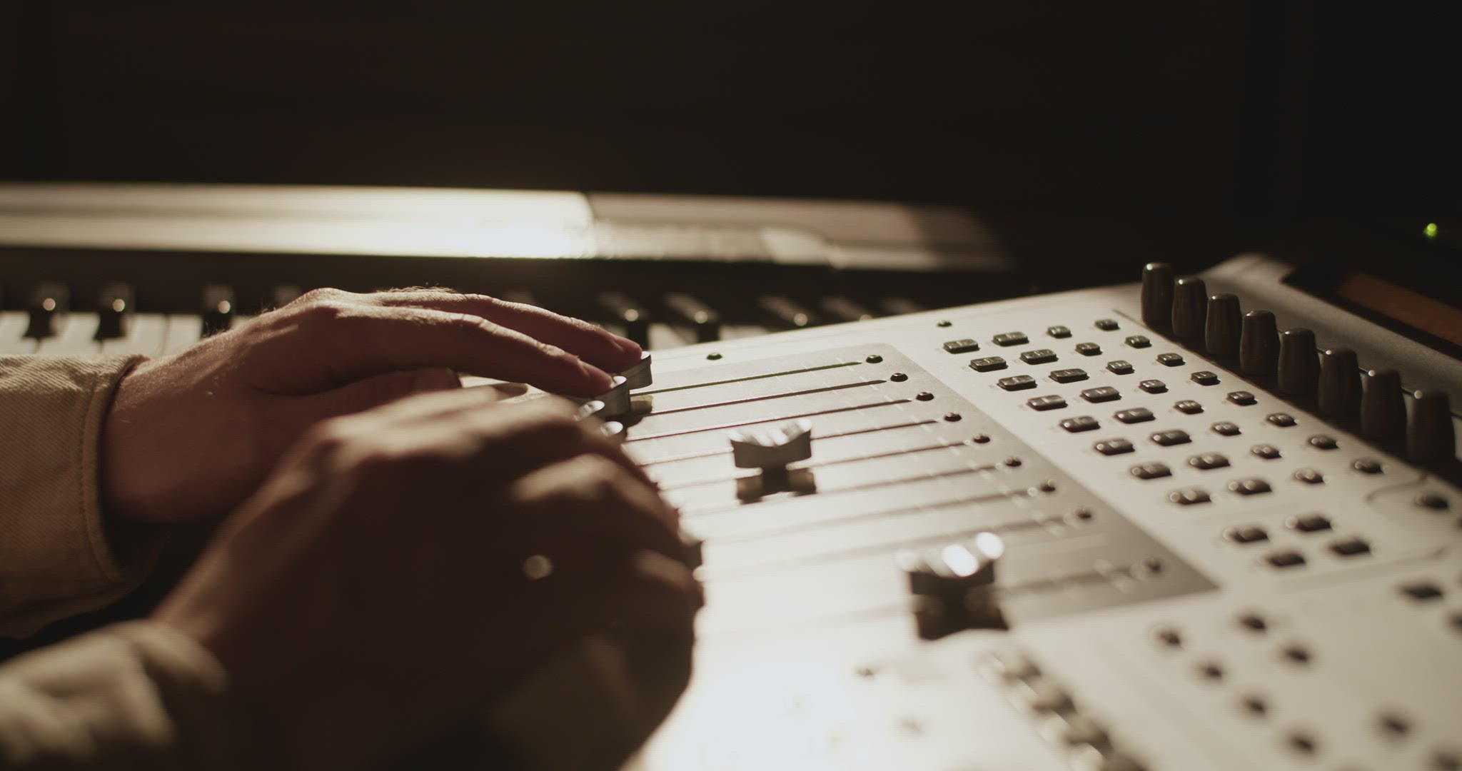 Producer using mixing console in studio