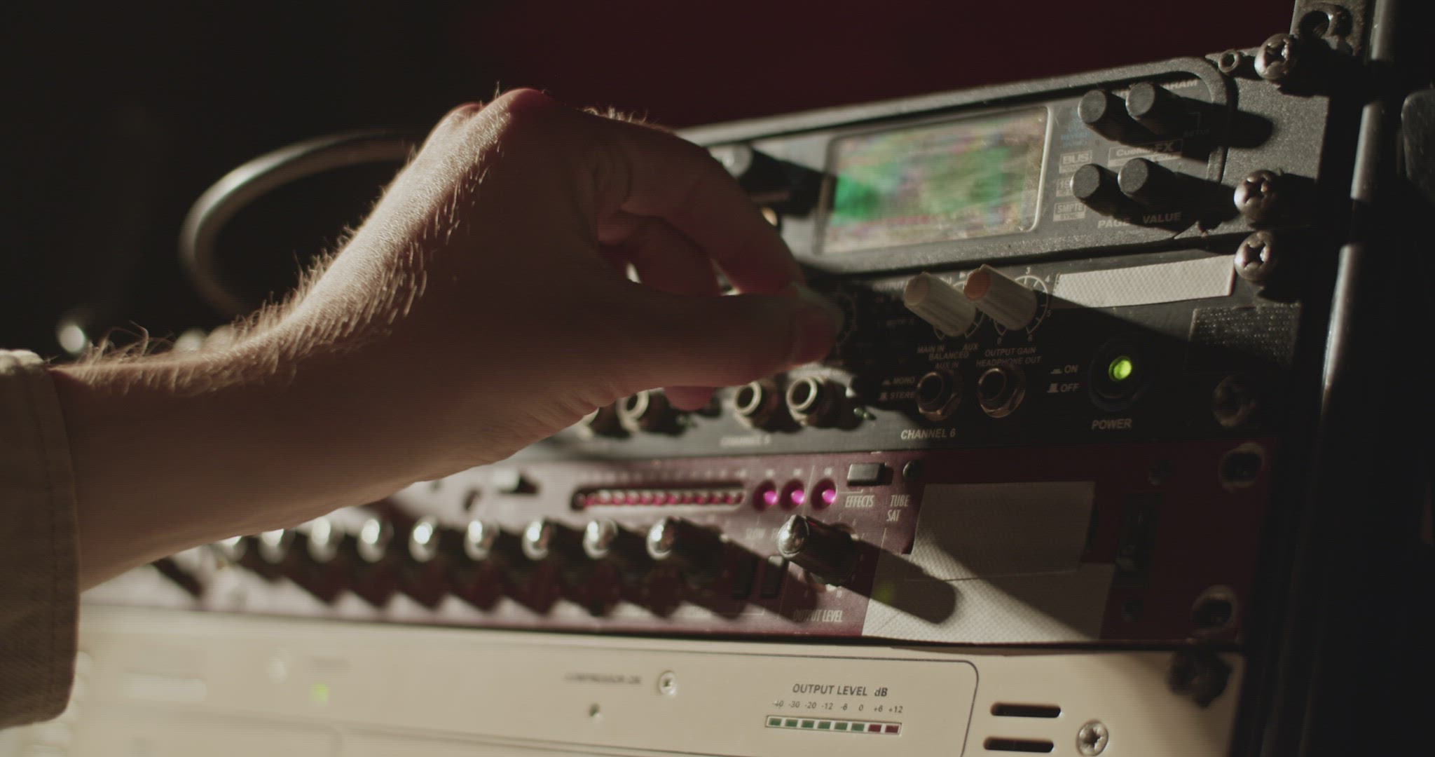 Musician tuning amplifier in studio