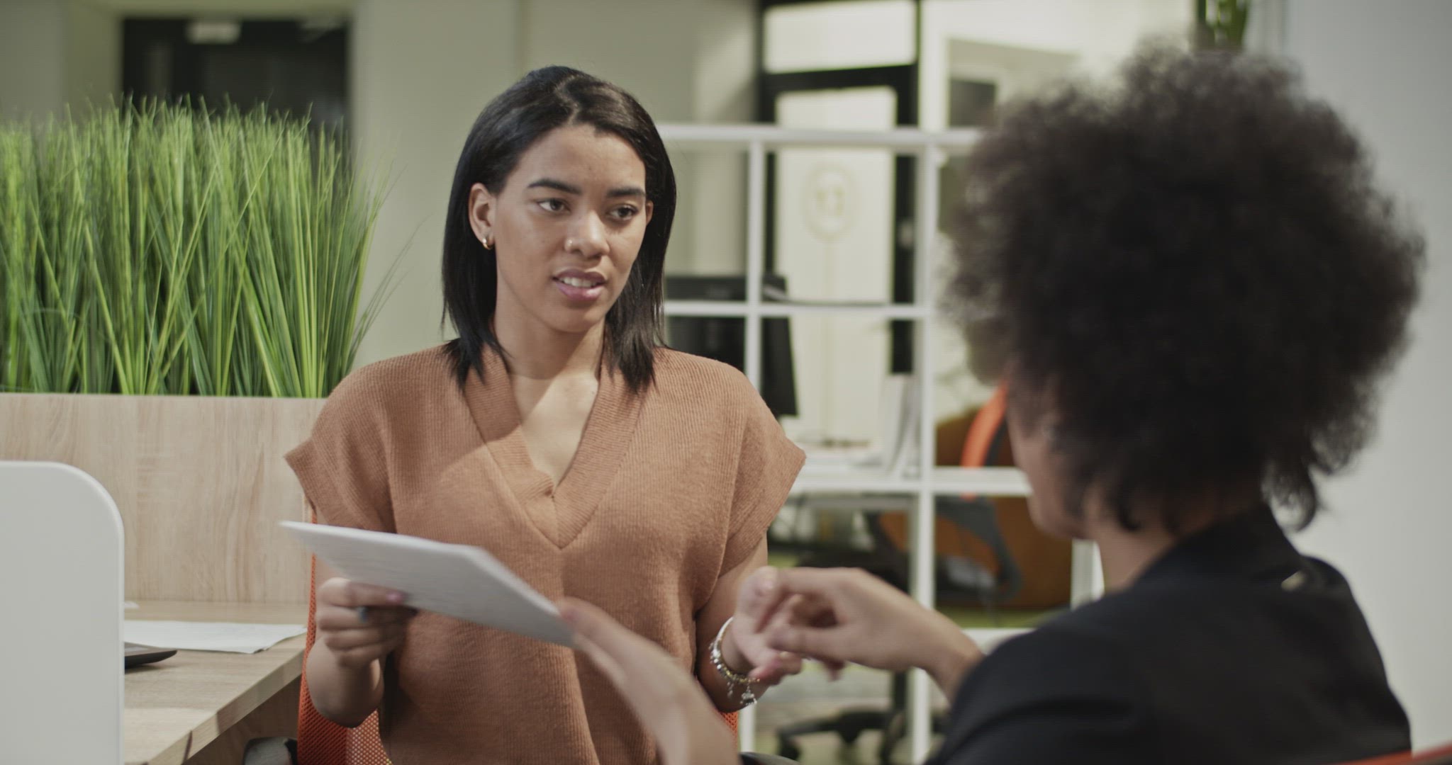 Black businesswomen doing paperwork together