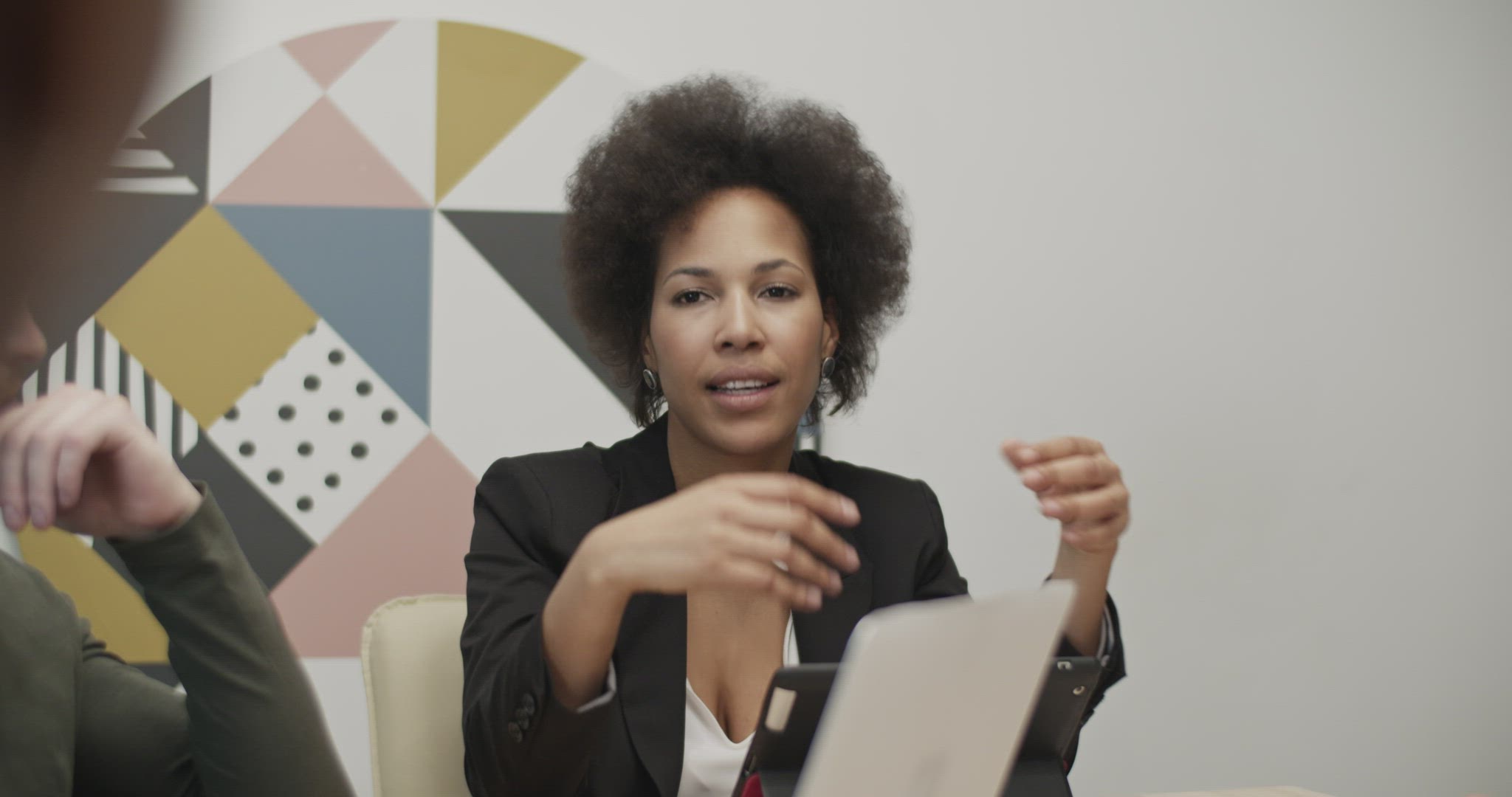African American businesswoman speaking to colleagues