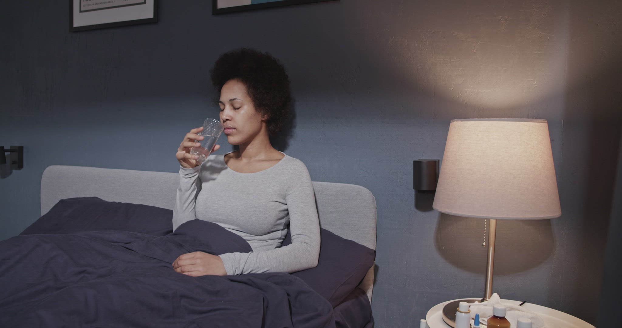 Sick black woman drinking water