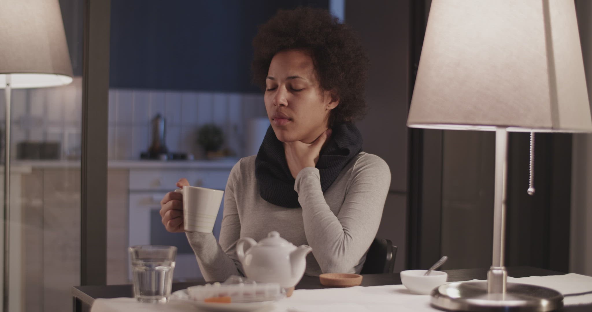 Woman with sore throat drinking tea