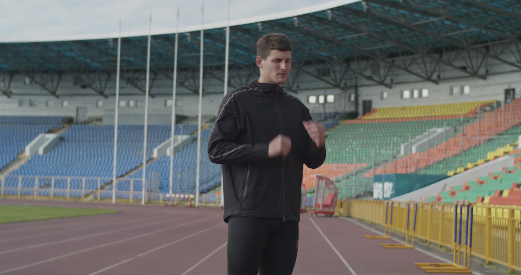 Sportswoman taking off tracksuit jacket
