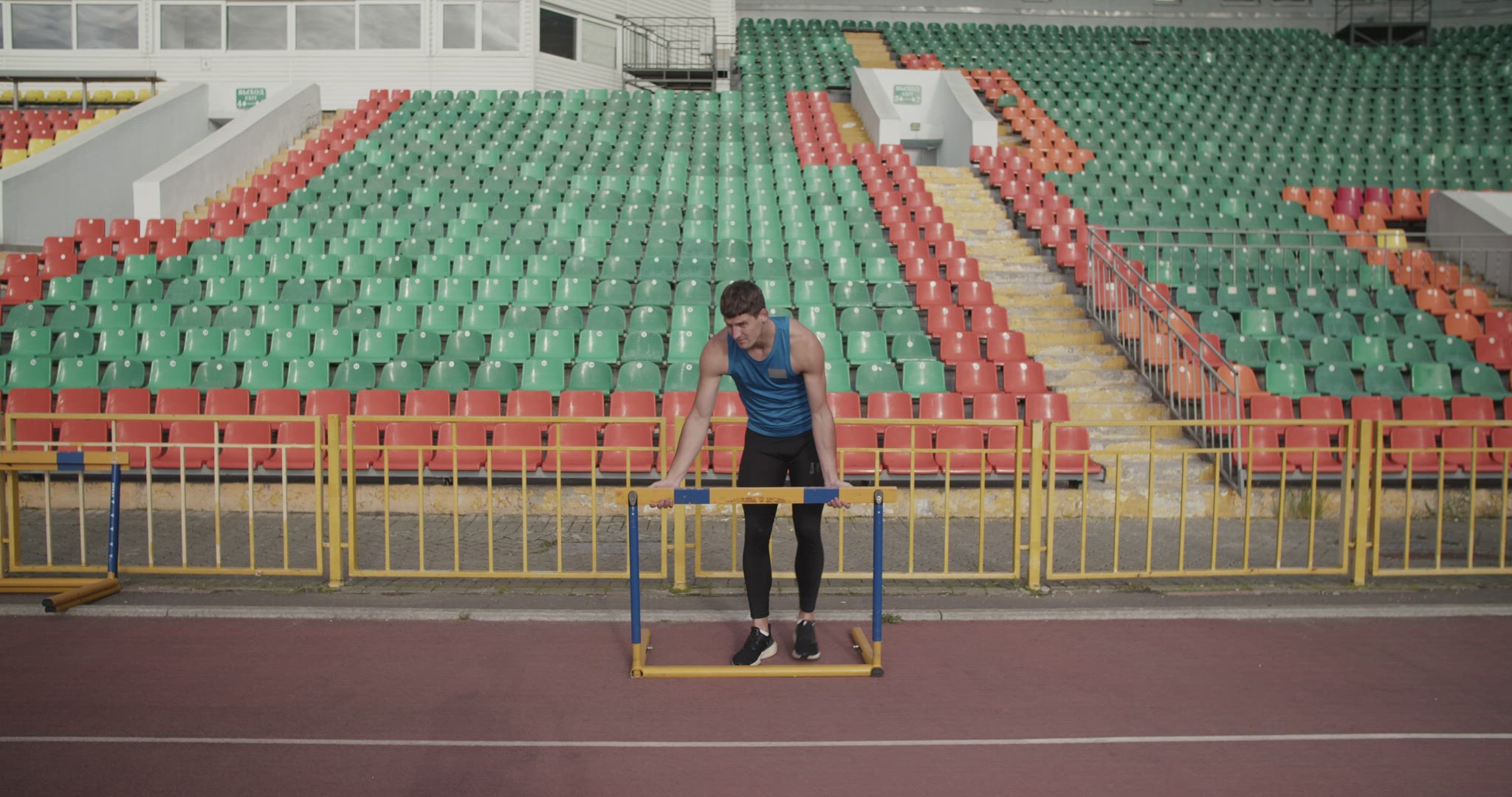 Sportsman preparing hurdle for workout