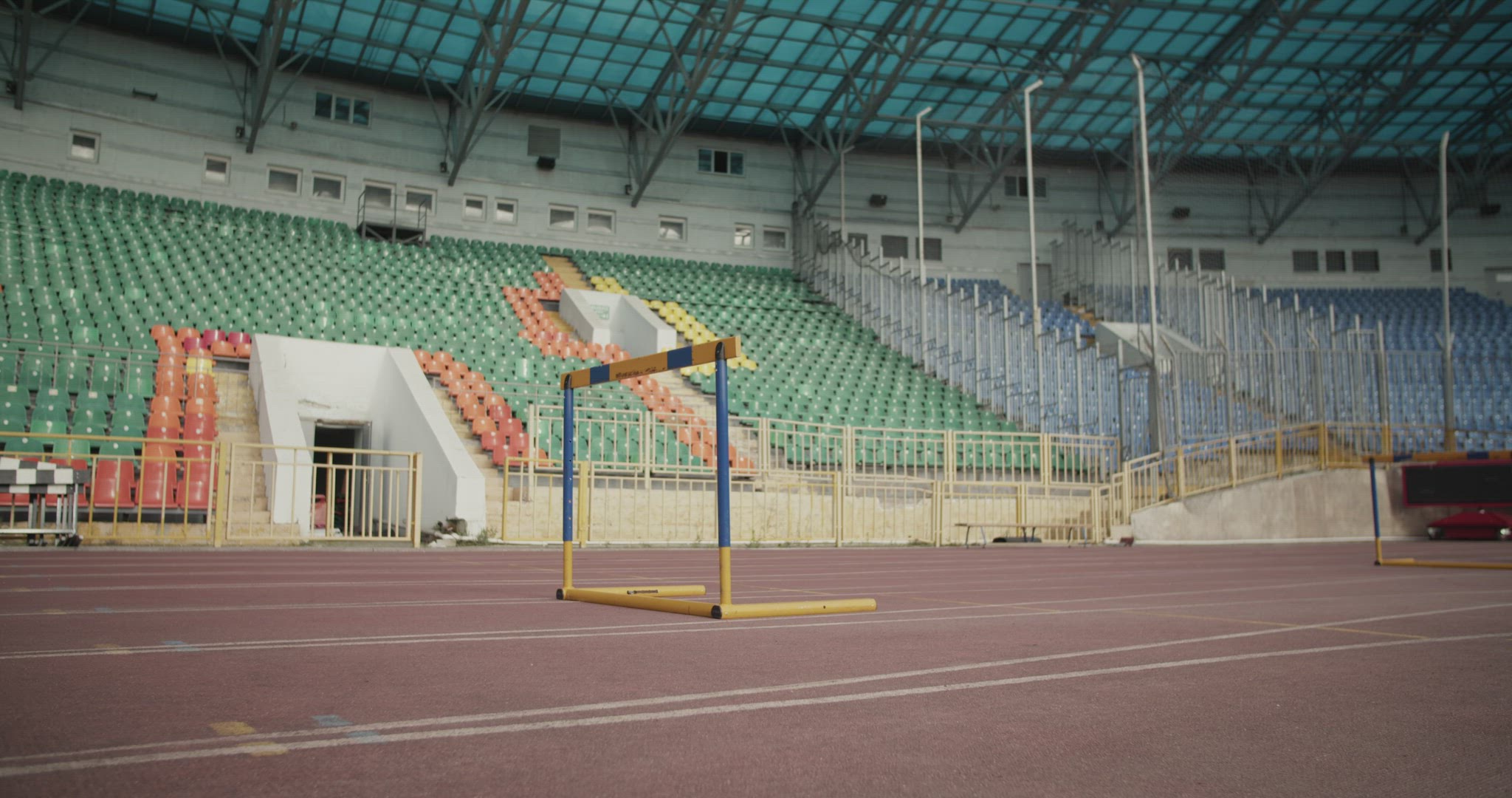 Young runner jumping over hurdle