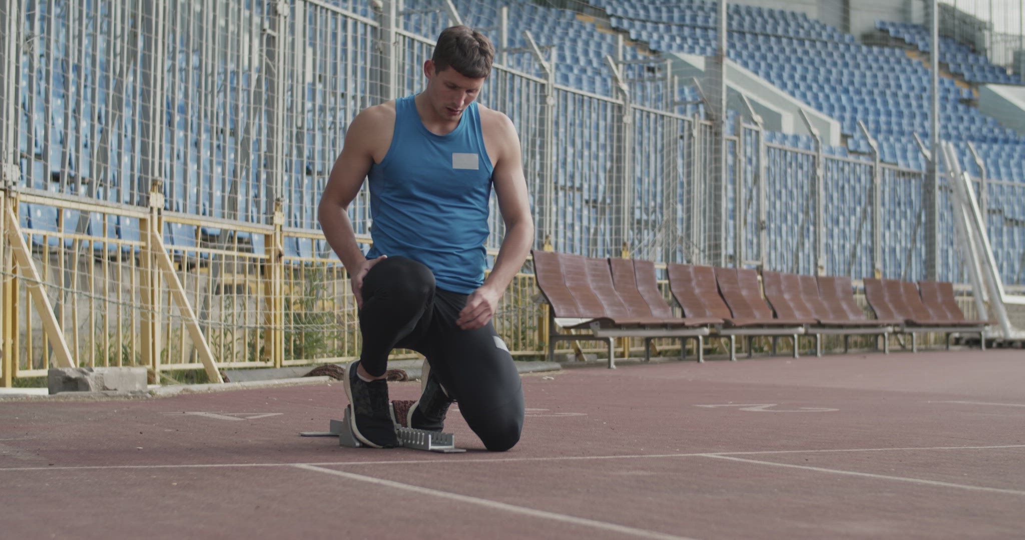 Young sprinter preparing to run