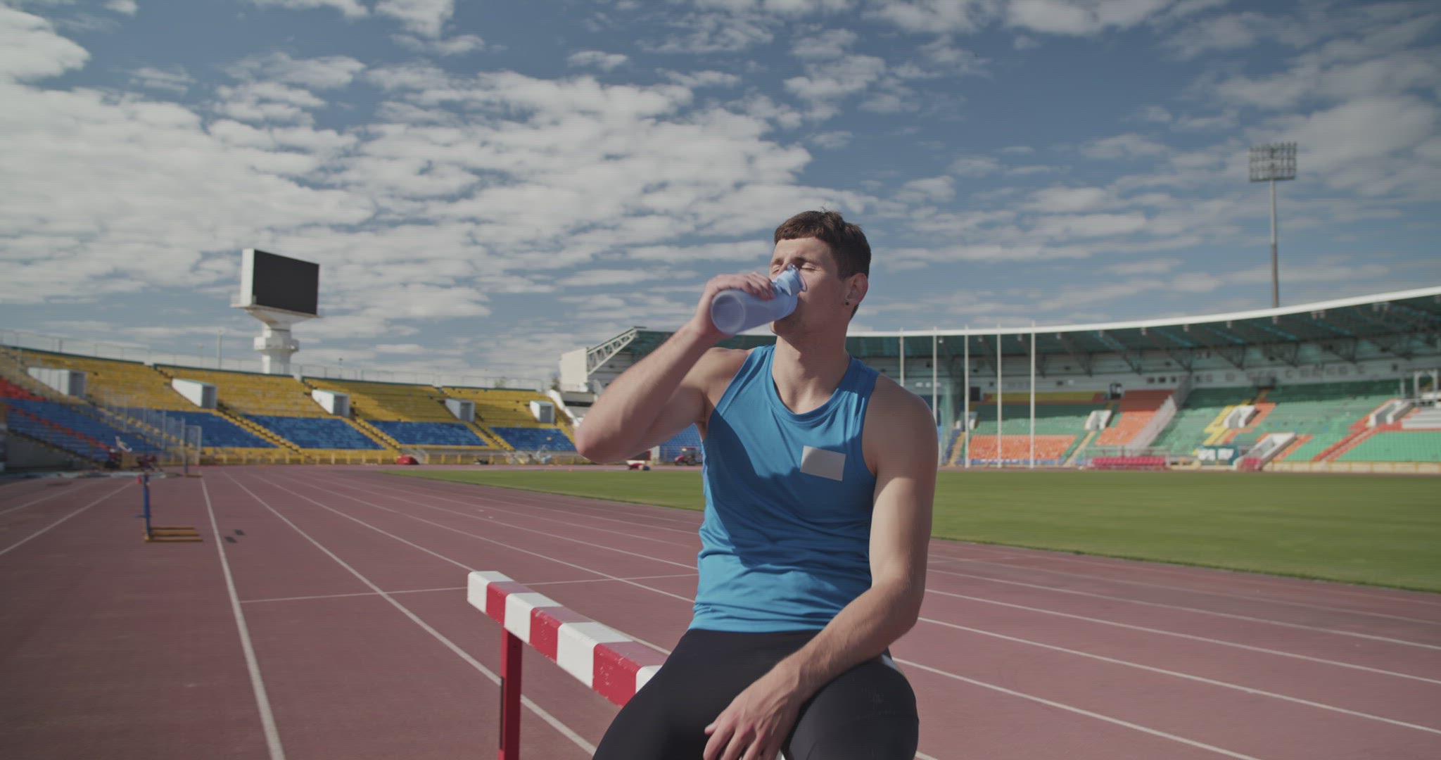 Sportsman drinking water during training