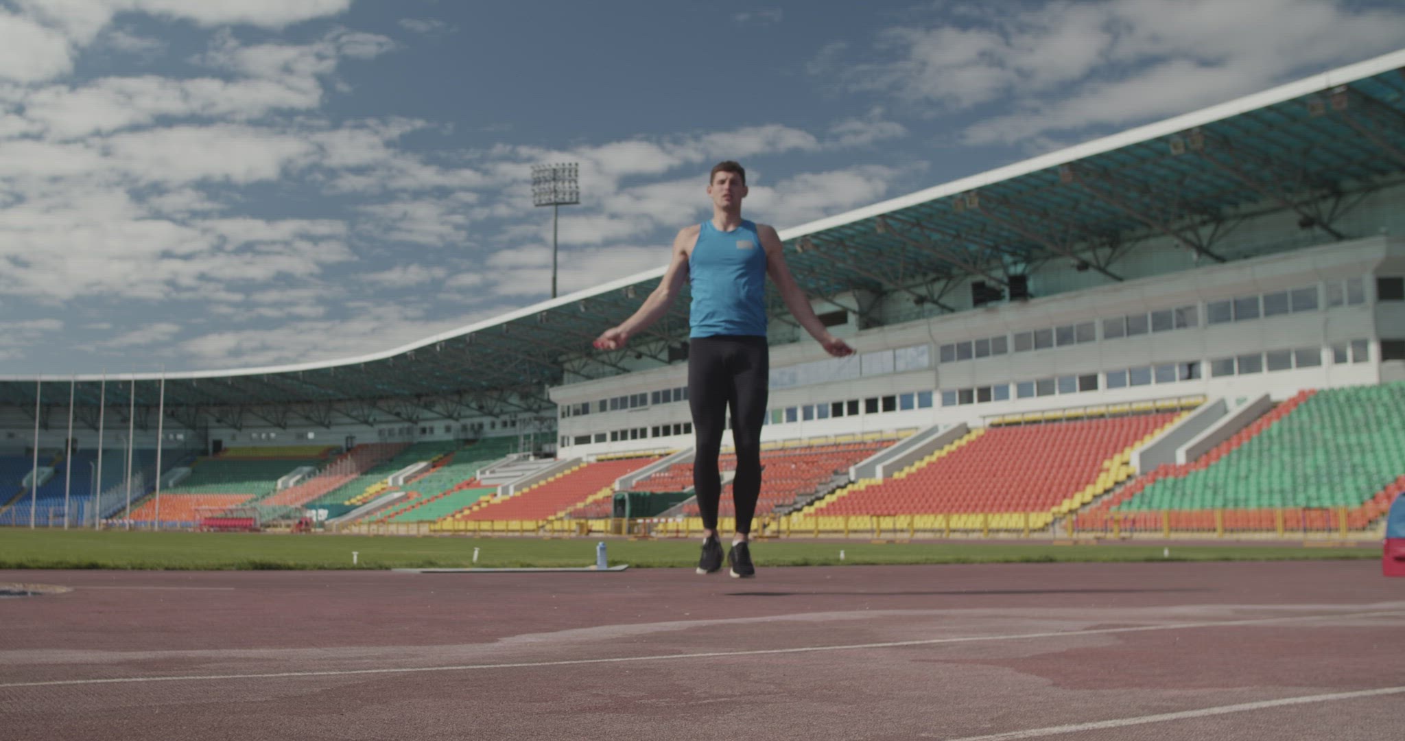Sportsman jumping with rope on stadium