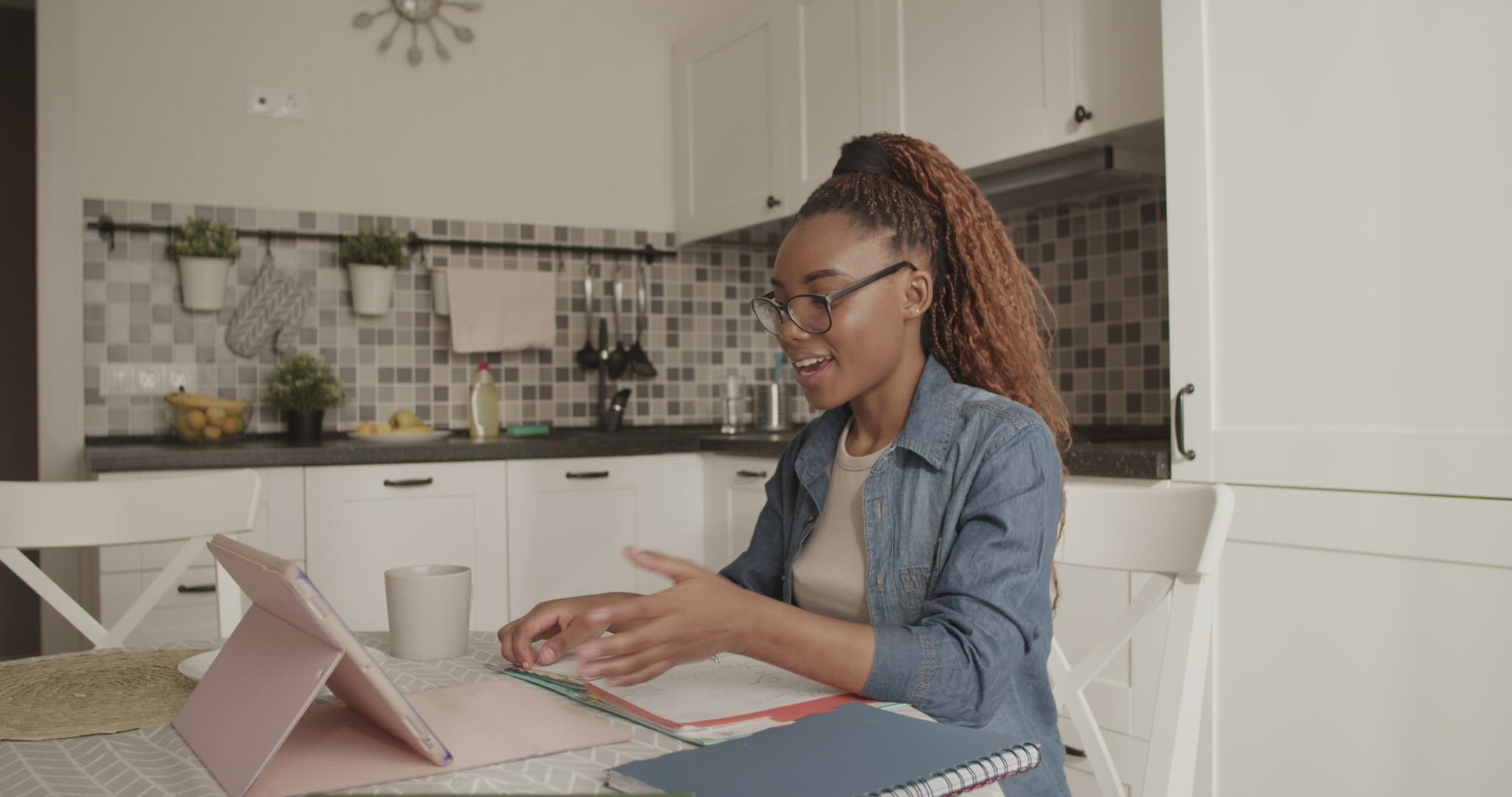 Black student discussing assignment with online teacher
