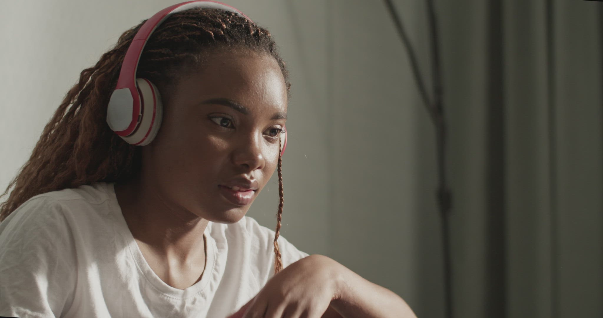 Nervous black woman watching film