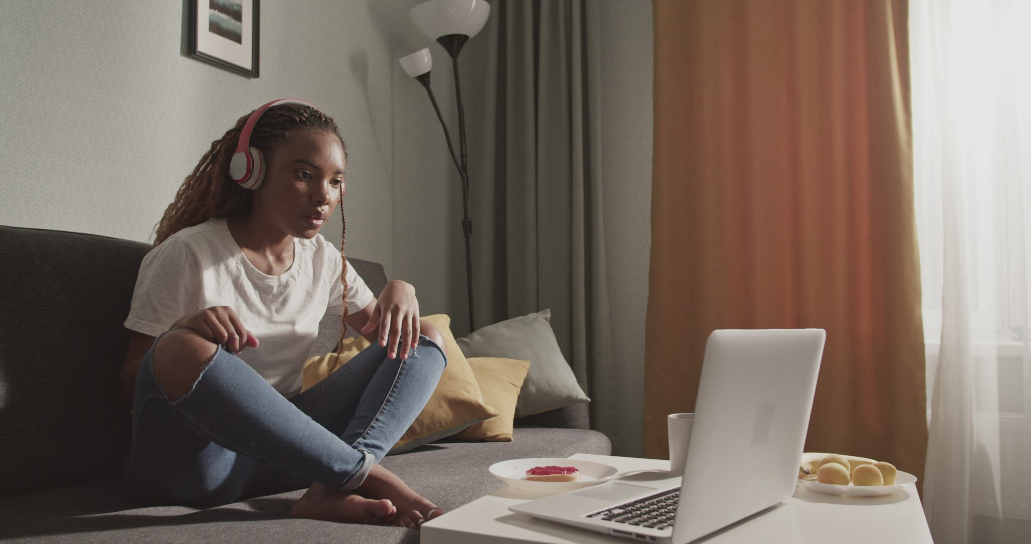 Nervous black woman watching film