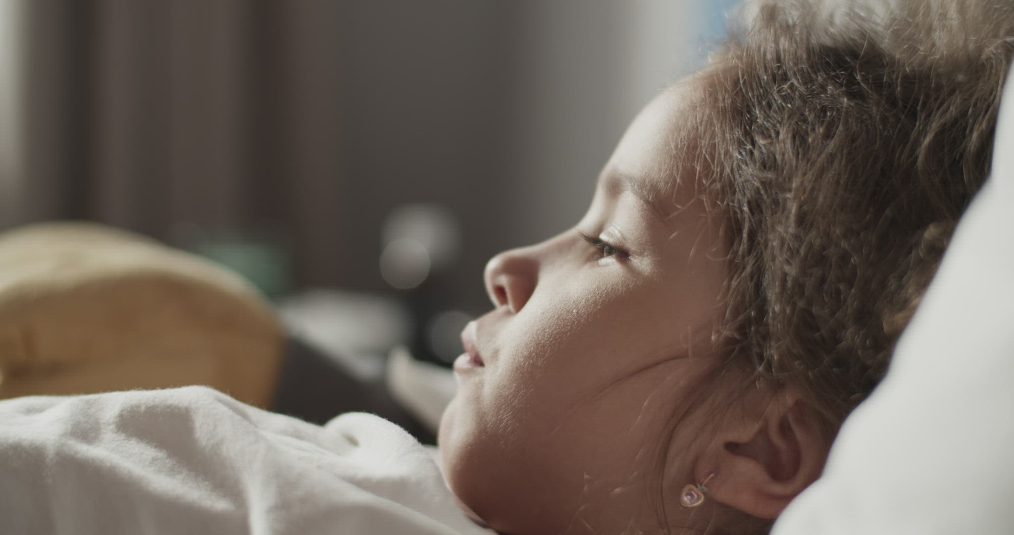 Mother measuring temperature of daughter