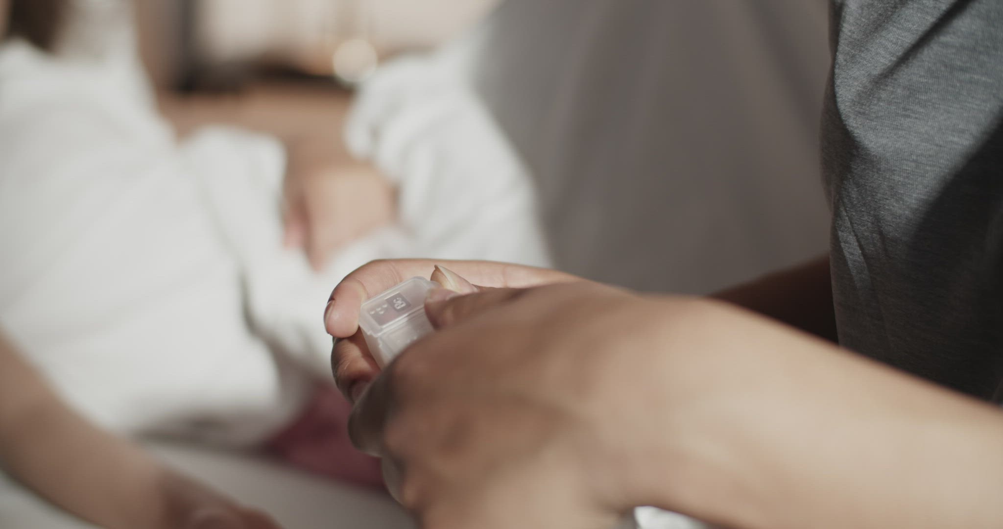 Mother giving medicine to ill daughter