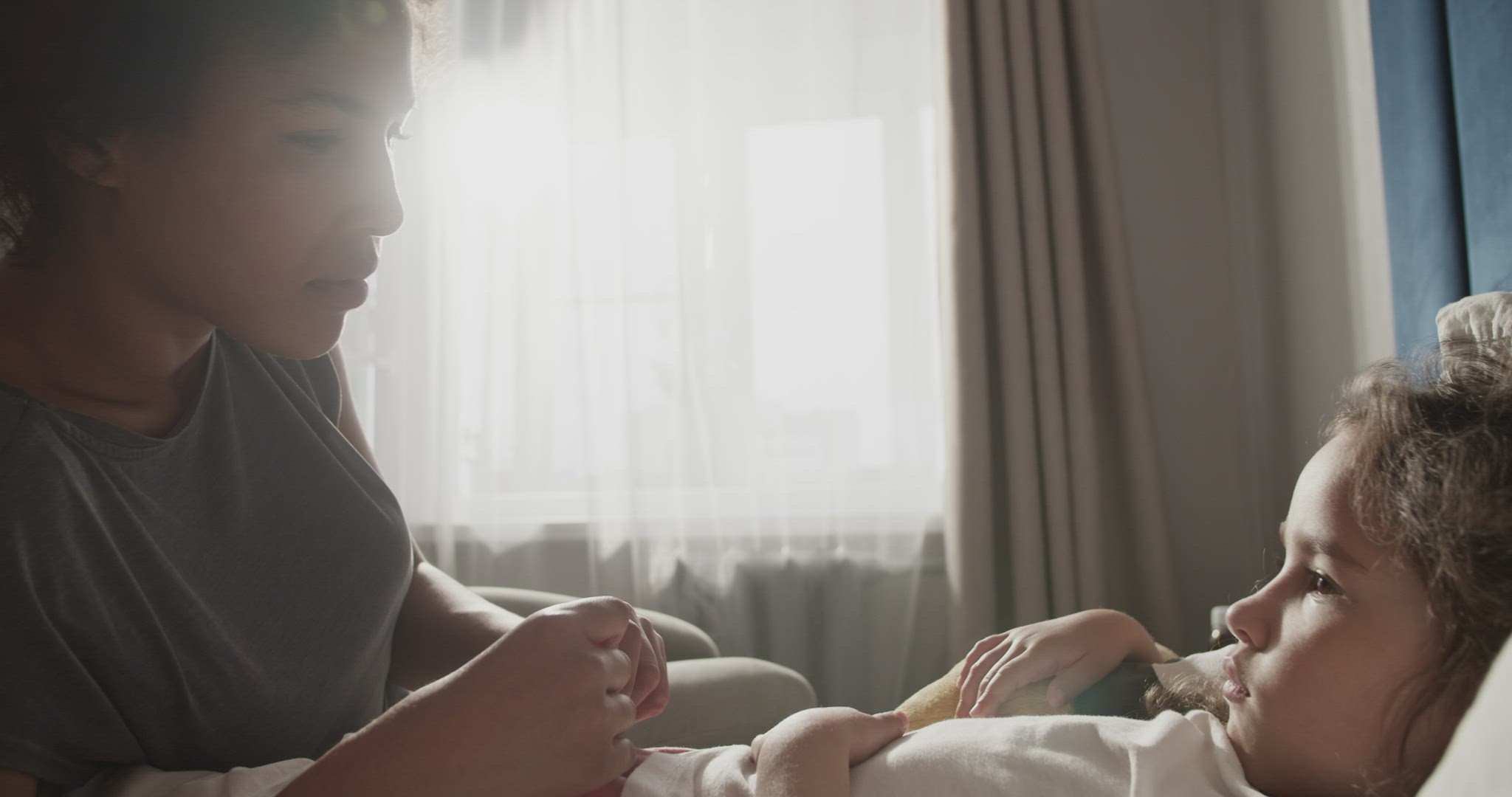 Mother and daughter measuring temperature and speaking