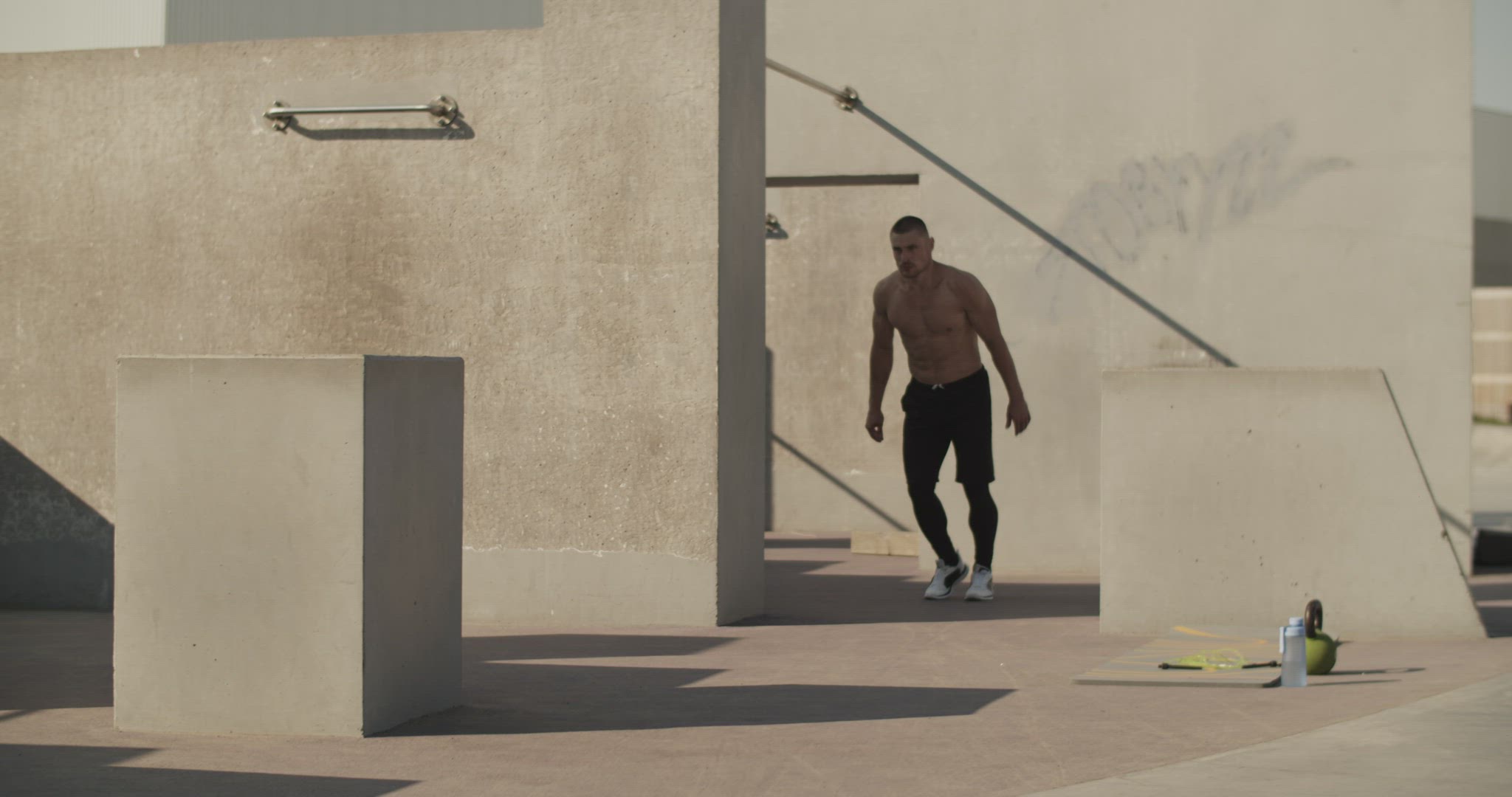 Male athlete leaping over barrier
