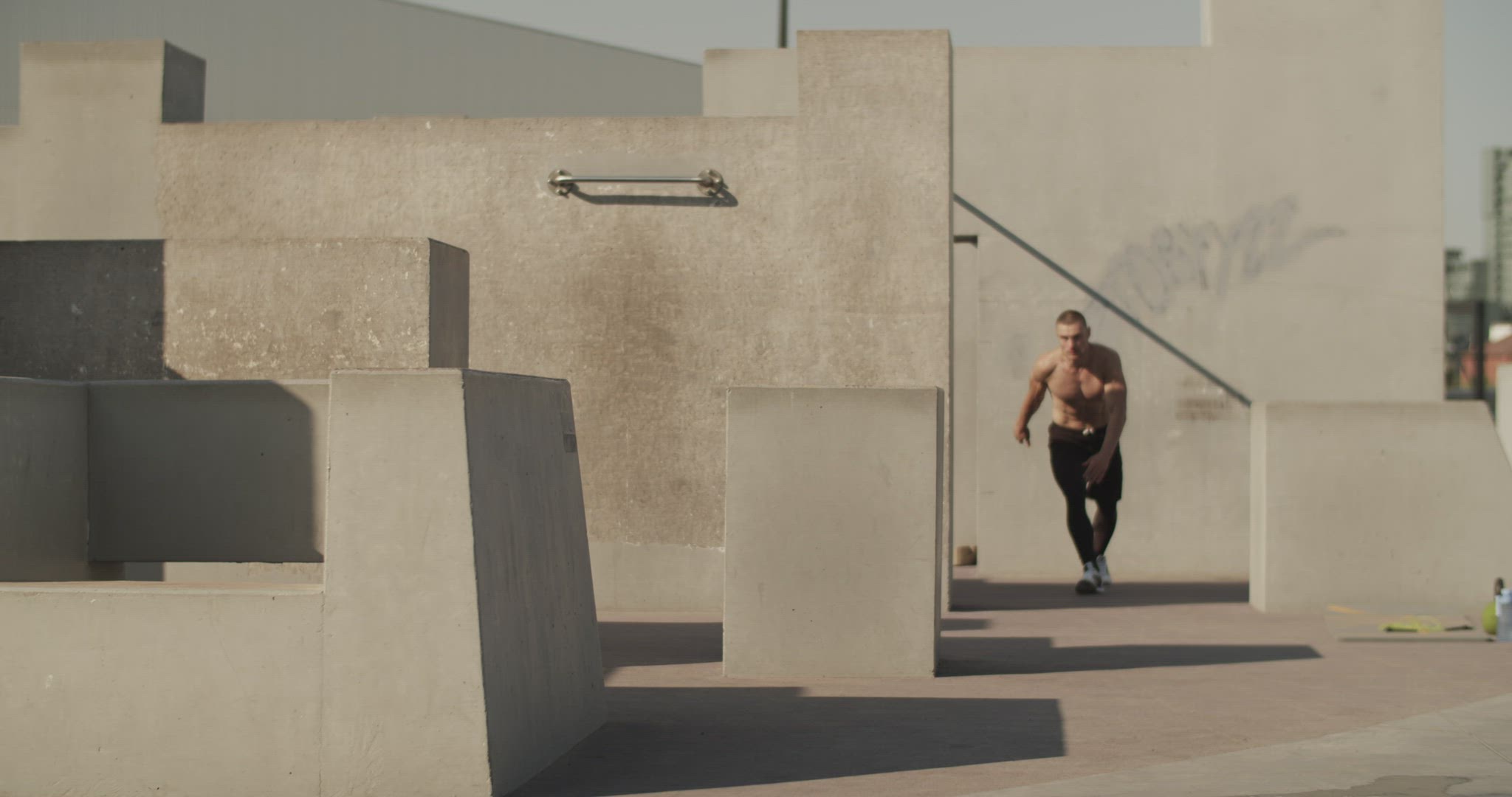 Male athlete leaping over barrier