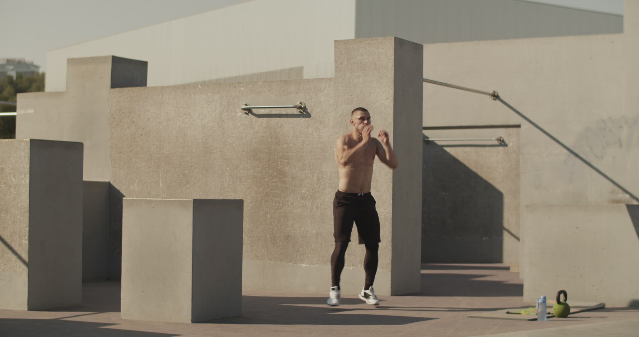 Sportsman doing jumping jacks on sports ground