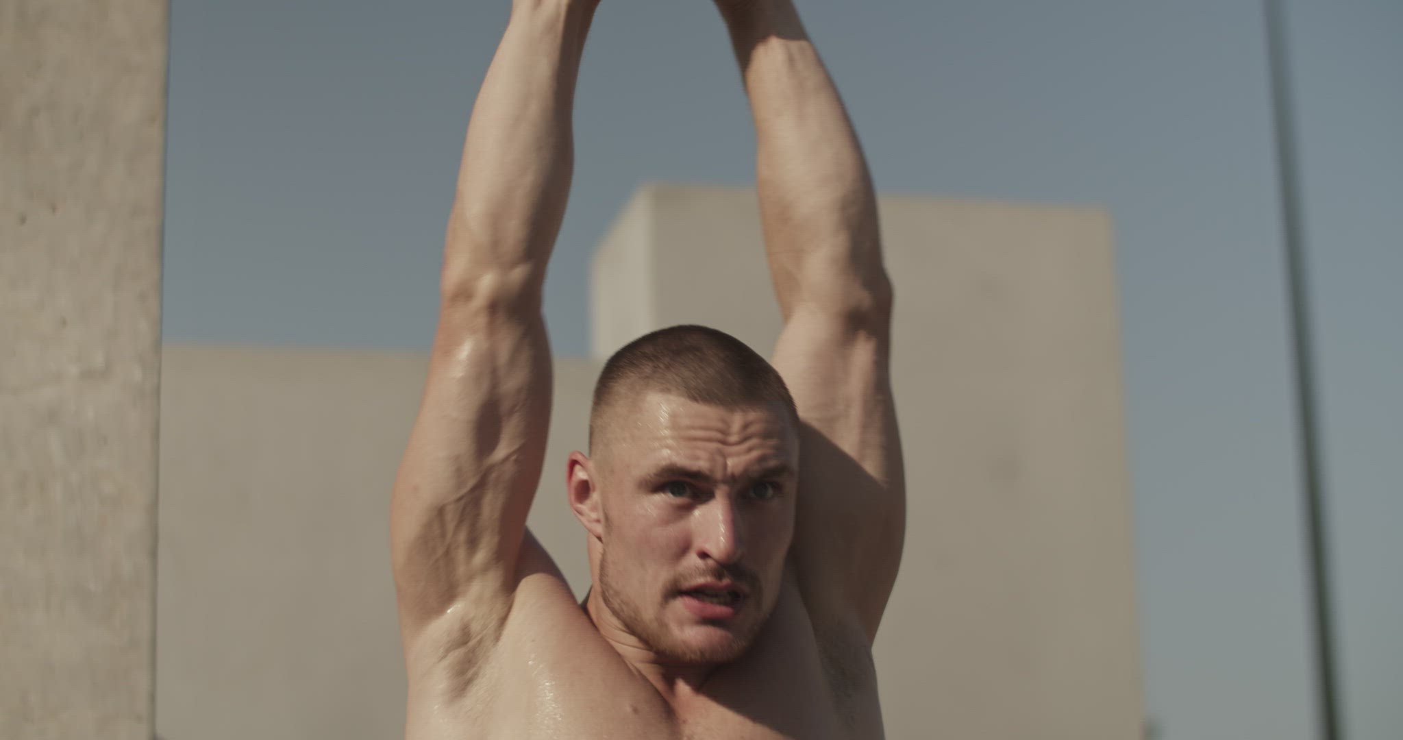 Male athlete doing kettlebell swings
