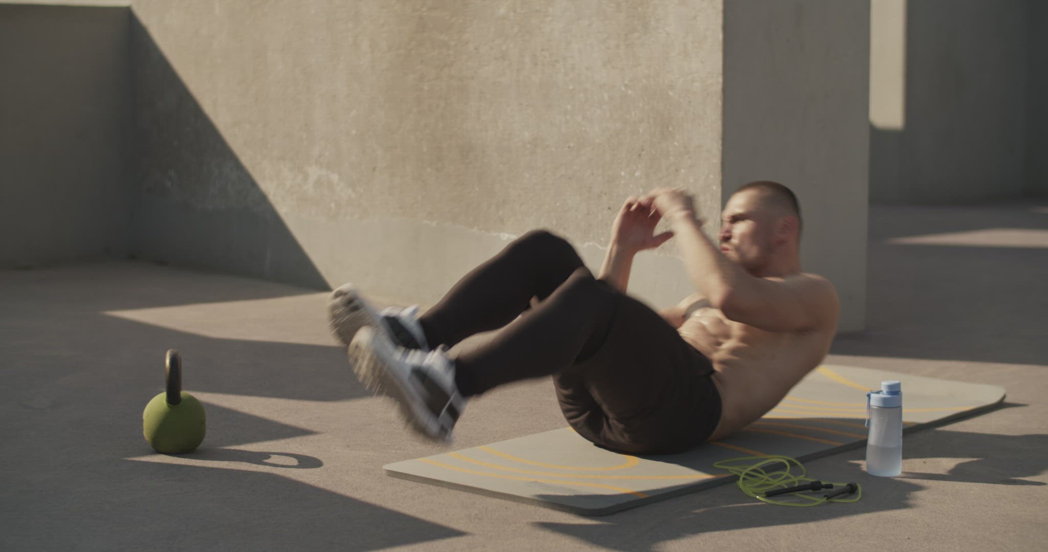 Sportsman doing abs exercise on sports ground